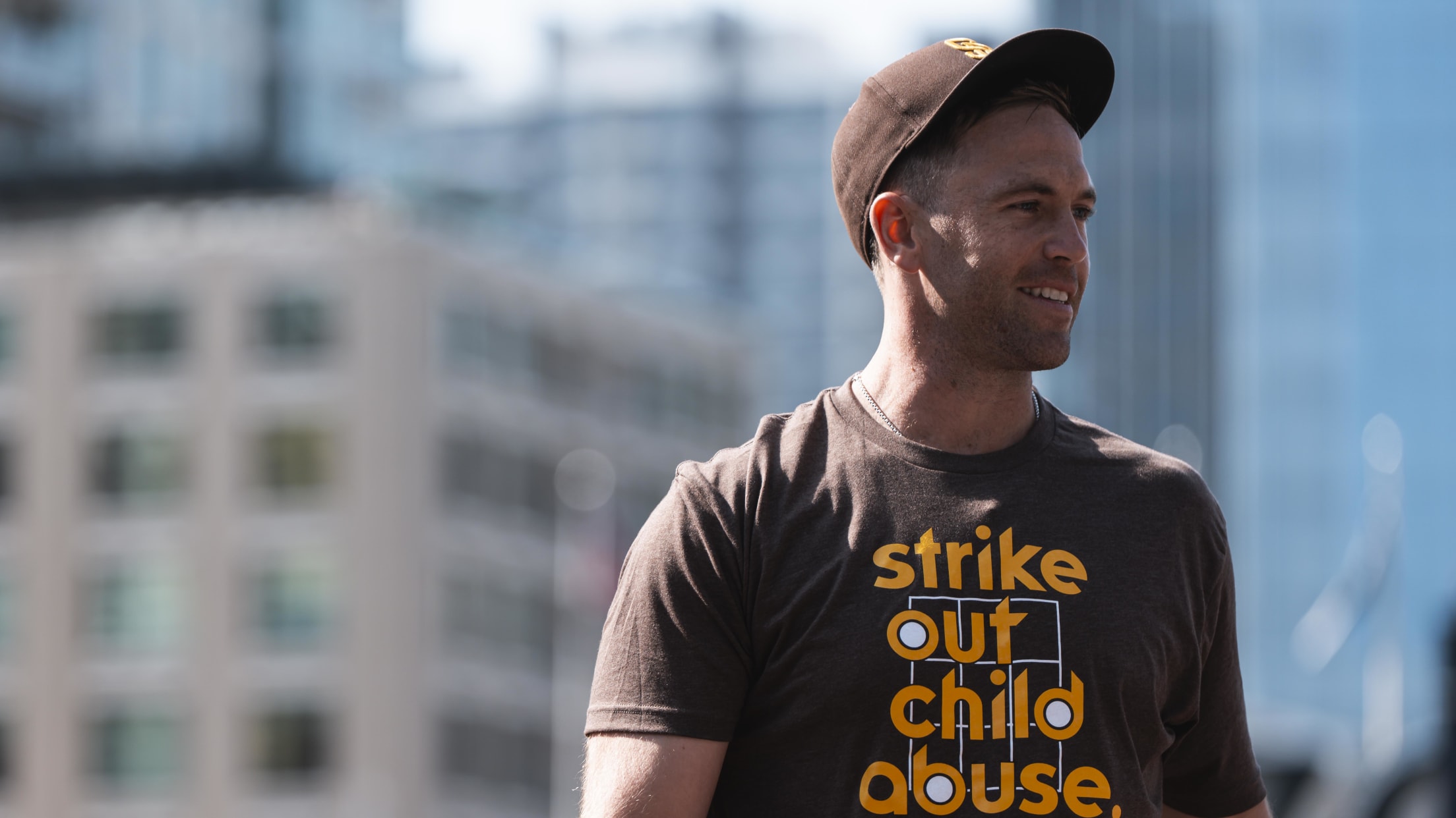 Jason Adam wears a "Strike Out Child Abuse" shirt.