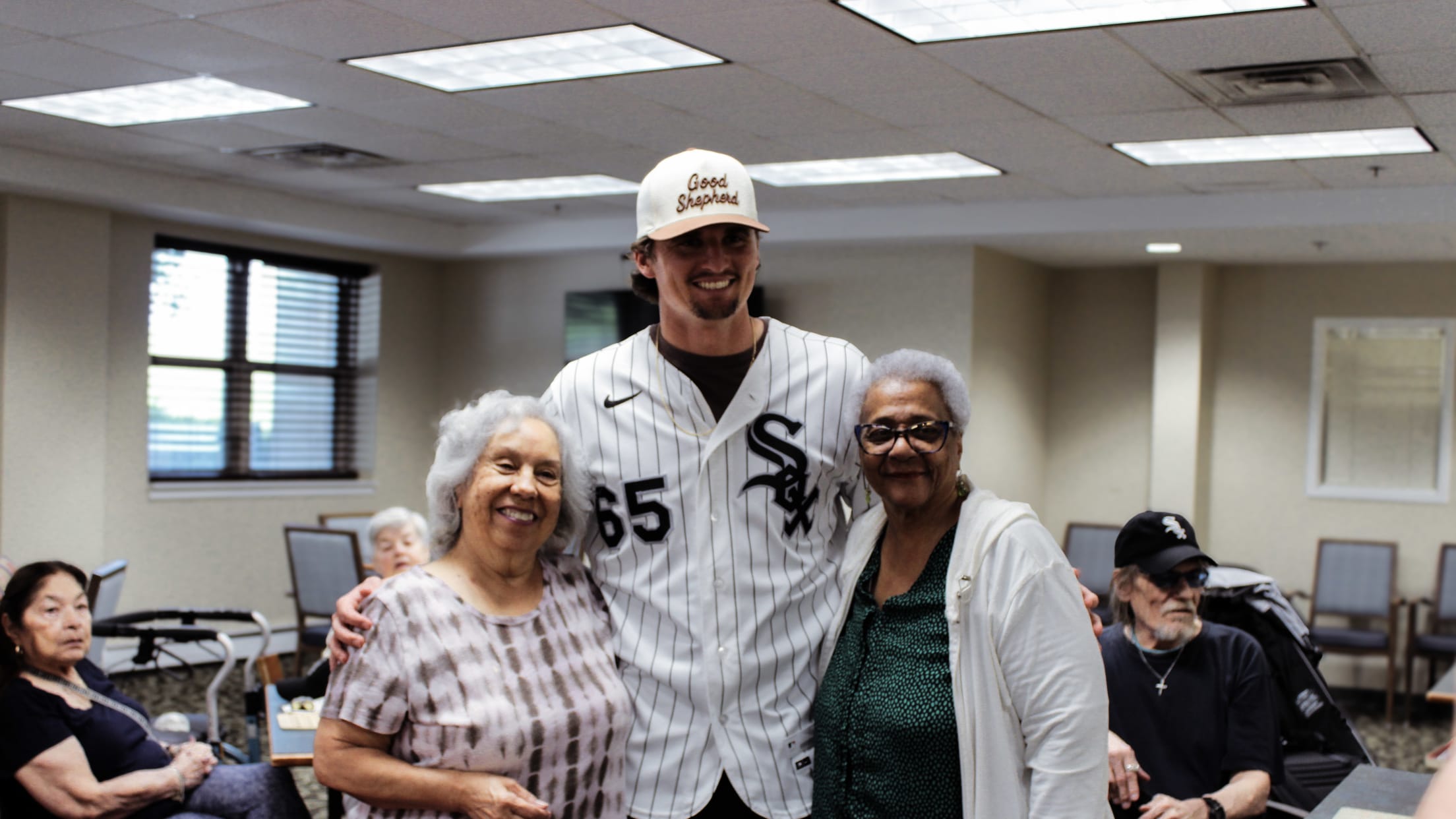 Davis Martin takes a picture with seniors at a Senior Suites event in Bridgeport.