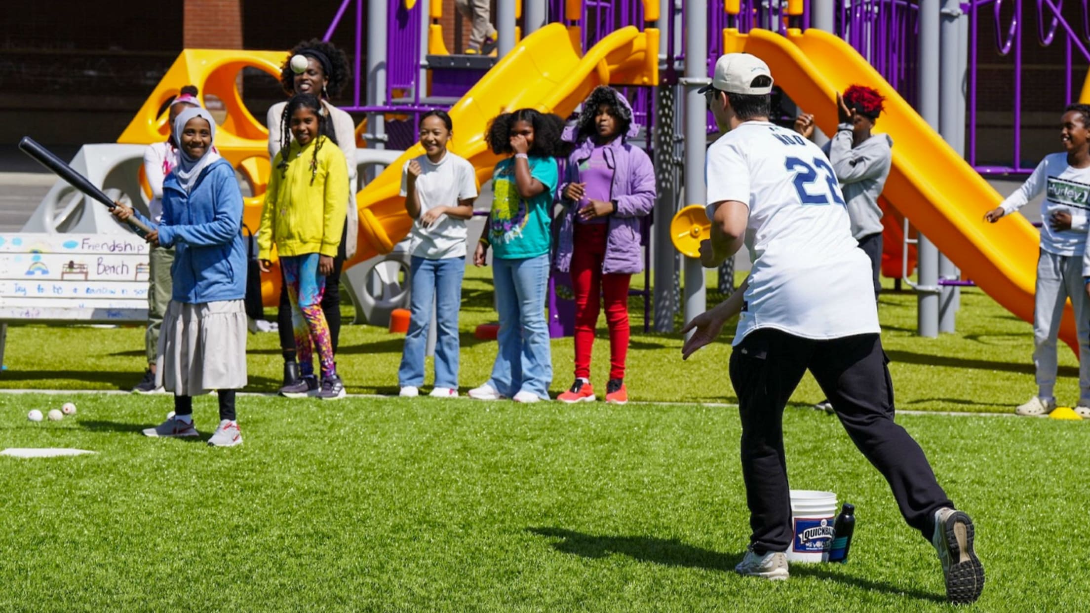 Image of Bryan Woo playing with young fans at recess.