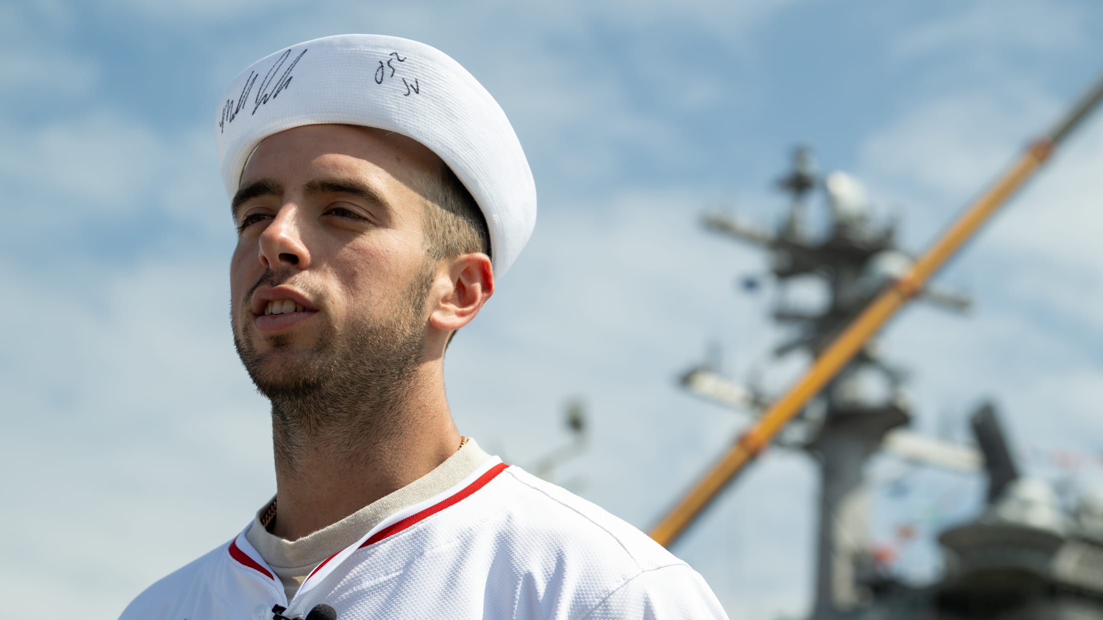 Zach Neto wears a United States Navy white hat.