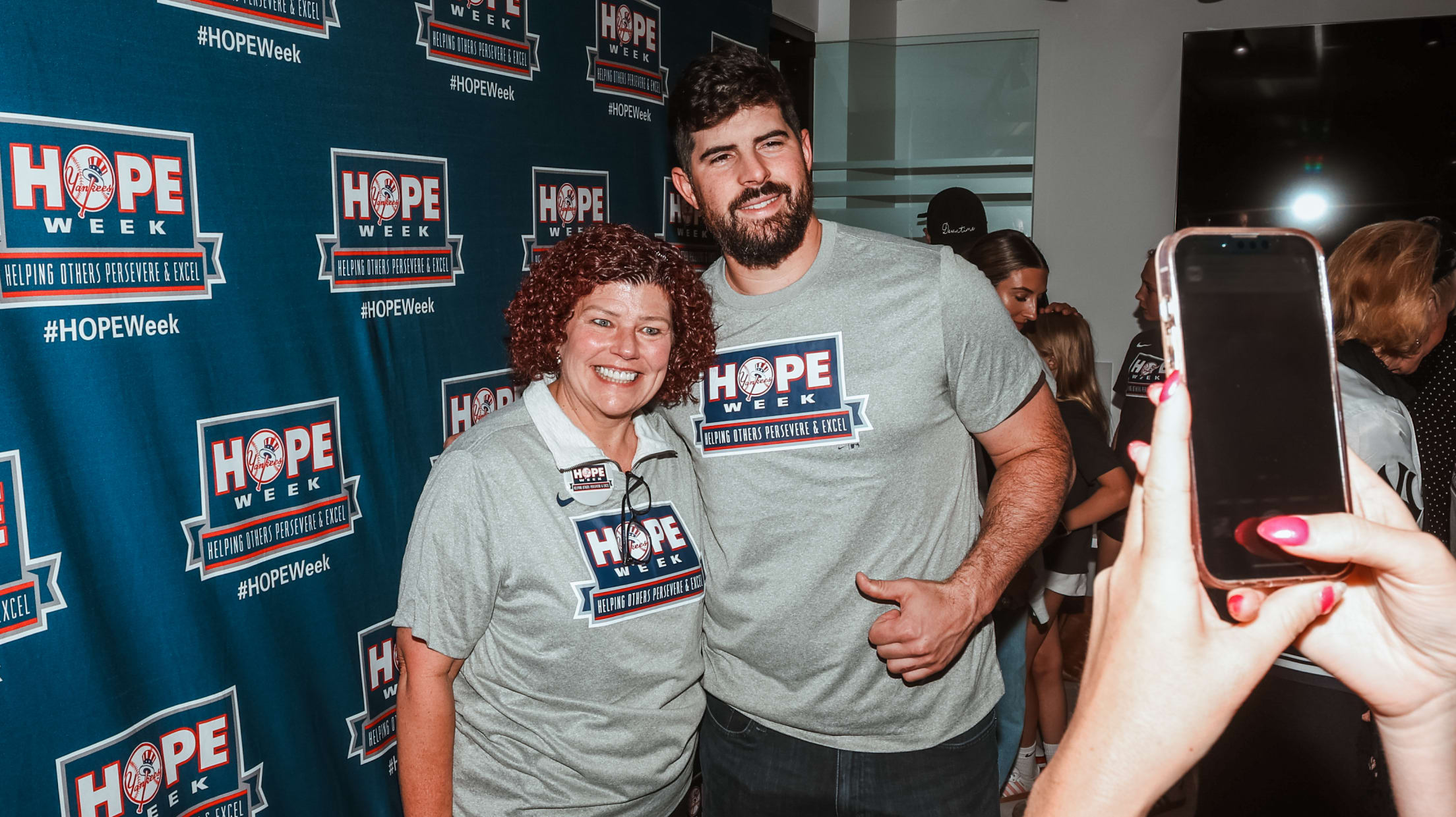Carlos Rodón and a woman pose for a photo during New York Yankees HOPE Week.