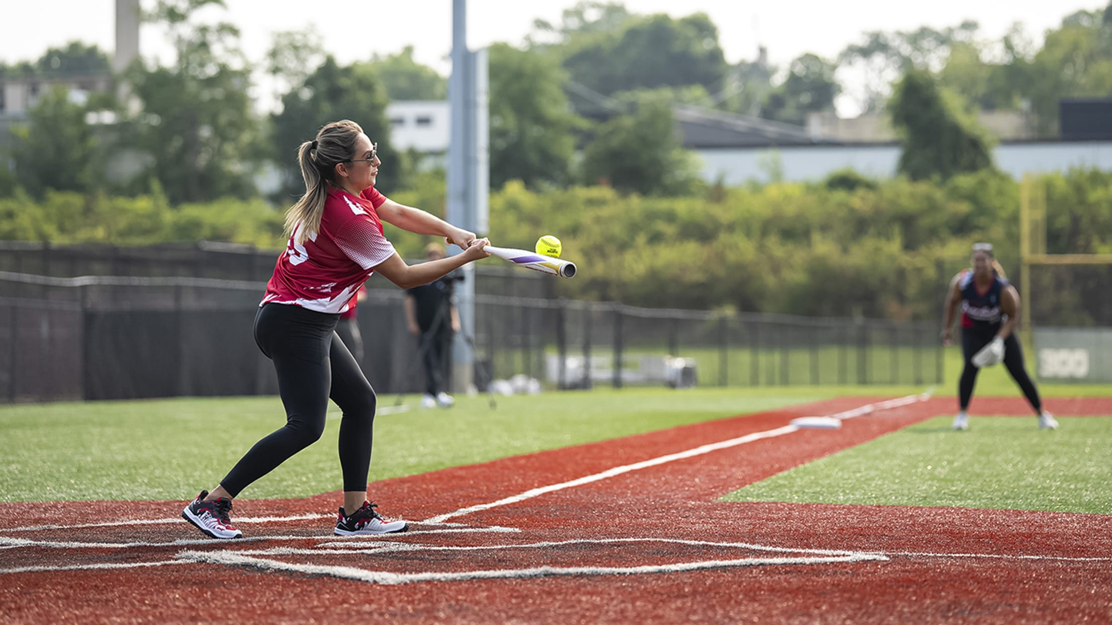 One of the Reds wives hits the softball.