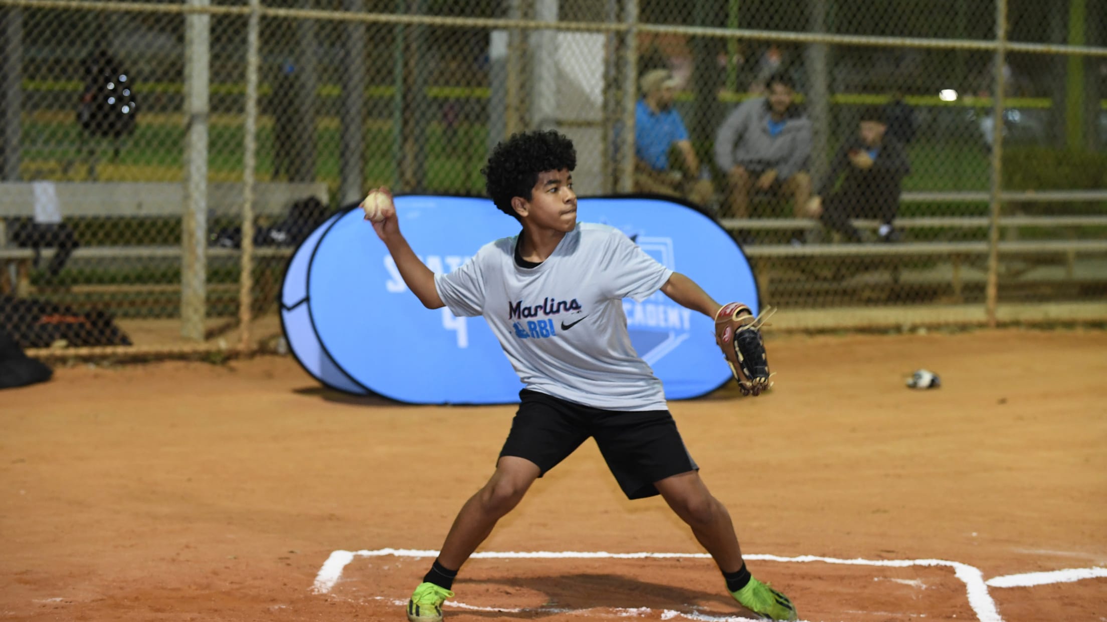 A player winds up to throw the ball from the batter's box during the Nike RBI Winter Development Clinic.
