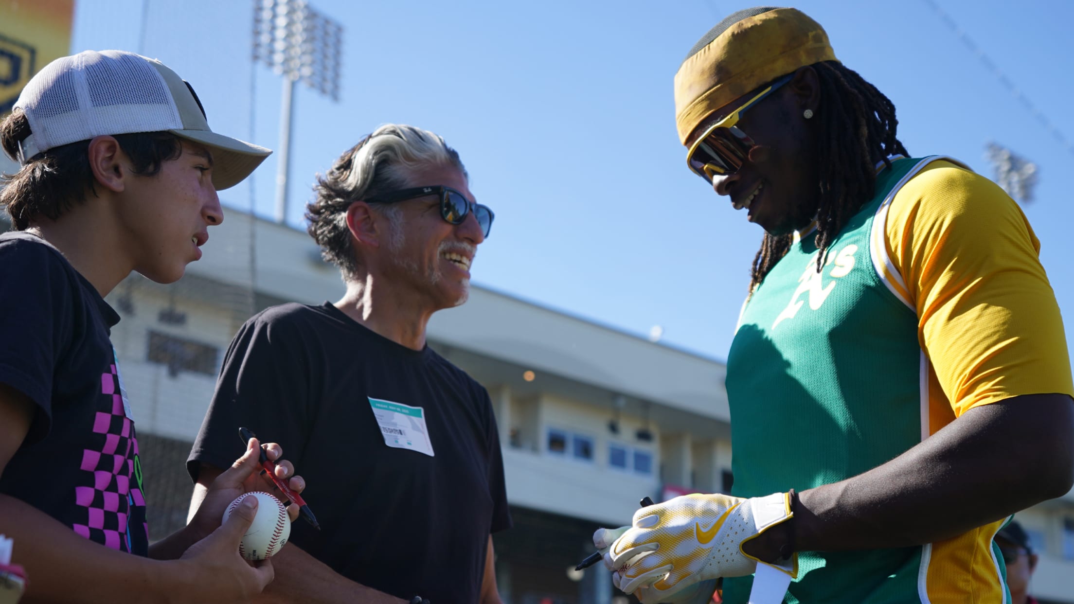 Lawrence Butler connects with fans during exclusive pregame batting practice access.
