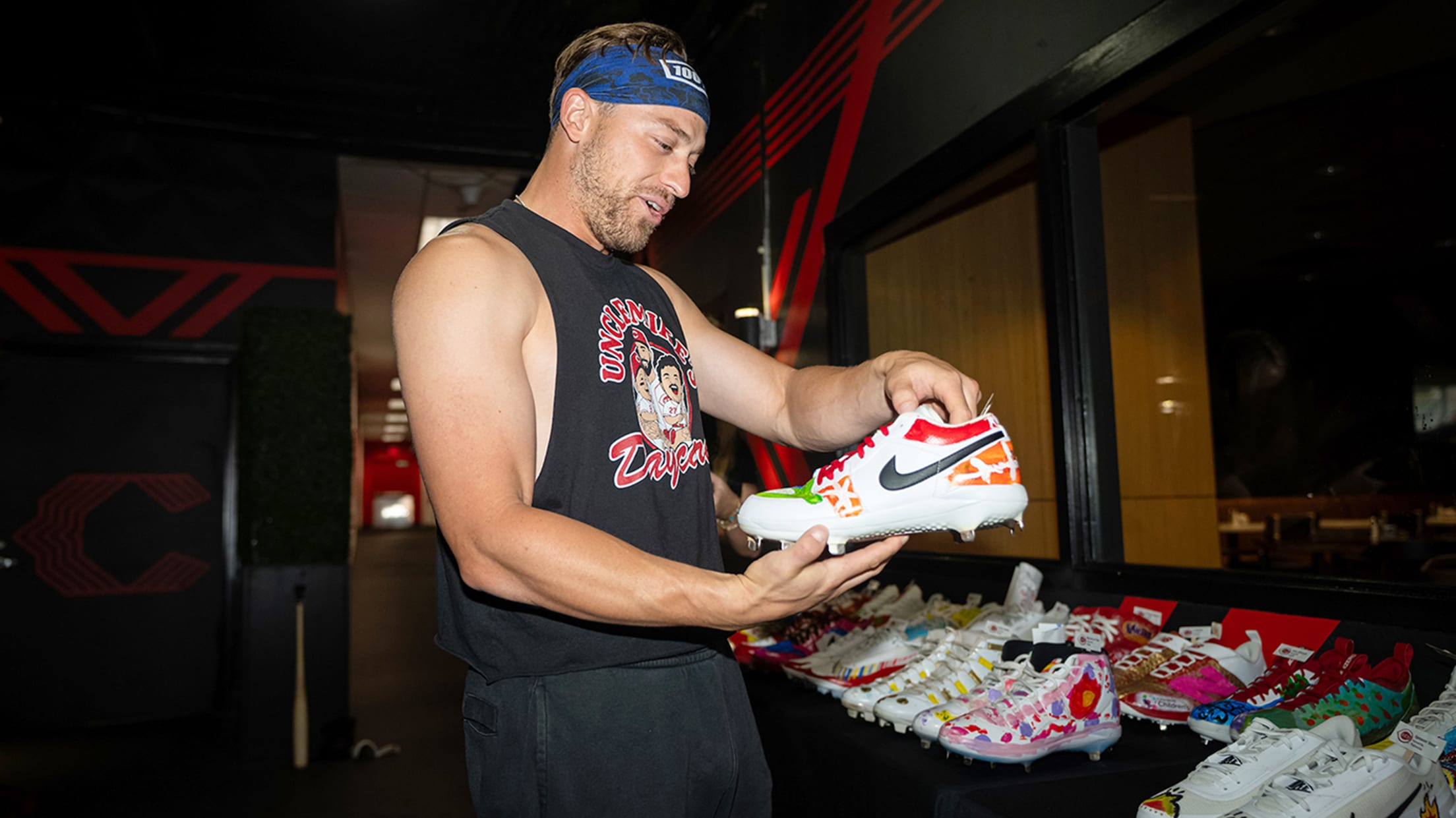 TJ Friedl looking happily at his cleats.