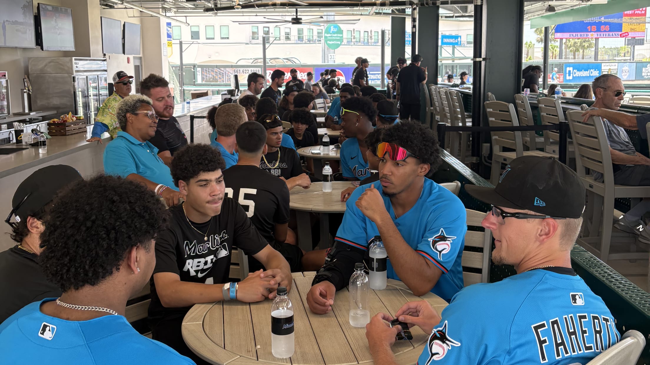 Players and fans hang out in an eating area during the Marlins Nike RBI All-Stars Southeast Regional tournament.
