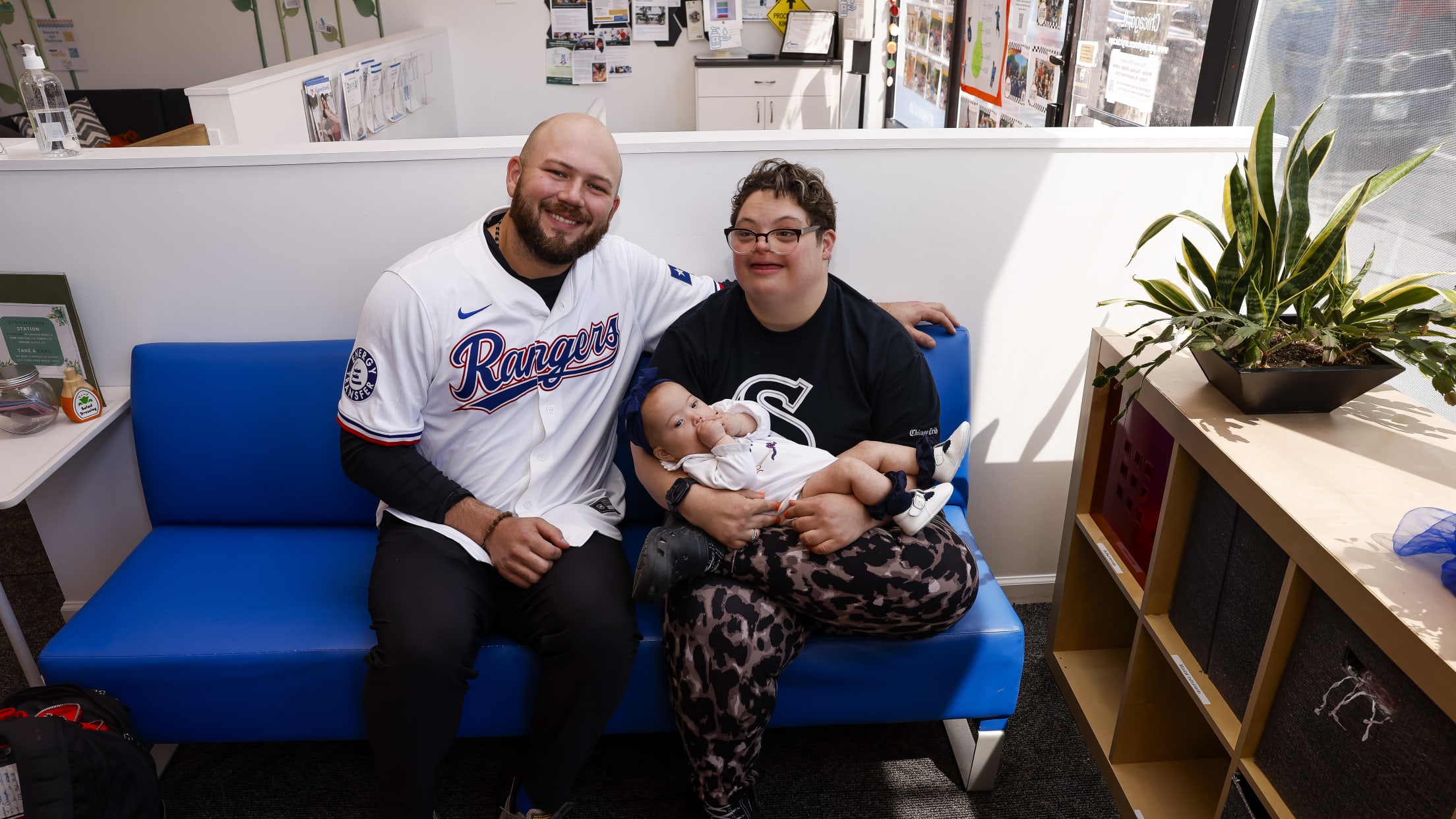 Jake Burger takes a photo with children during his visit to Gigi's Playhouse.
