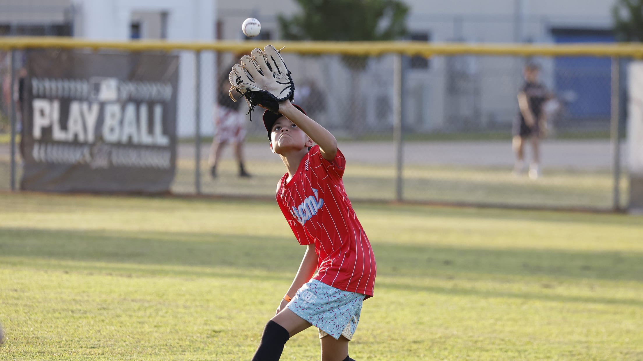 A player catches a fly ball in the outfield at the MLBPAA Legends for Youth Clinic.