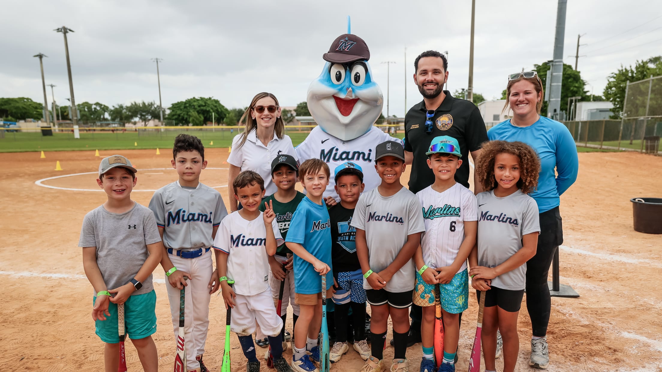 Players, coaches and Billy the Marlin pose for a photo at MLB Pitch, Hit & Run.