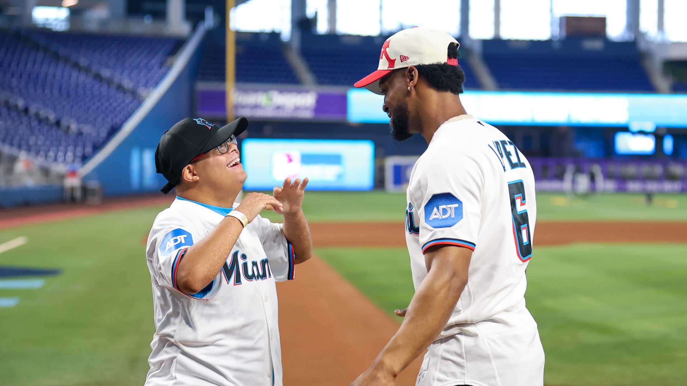 Otto Lopez meets an excited fan at home plate at loanDepot Park.