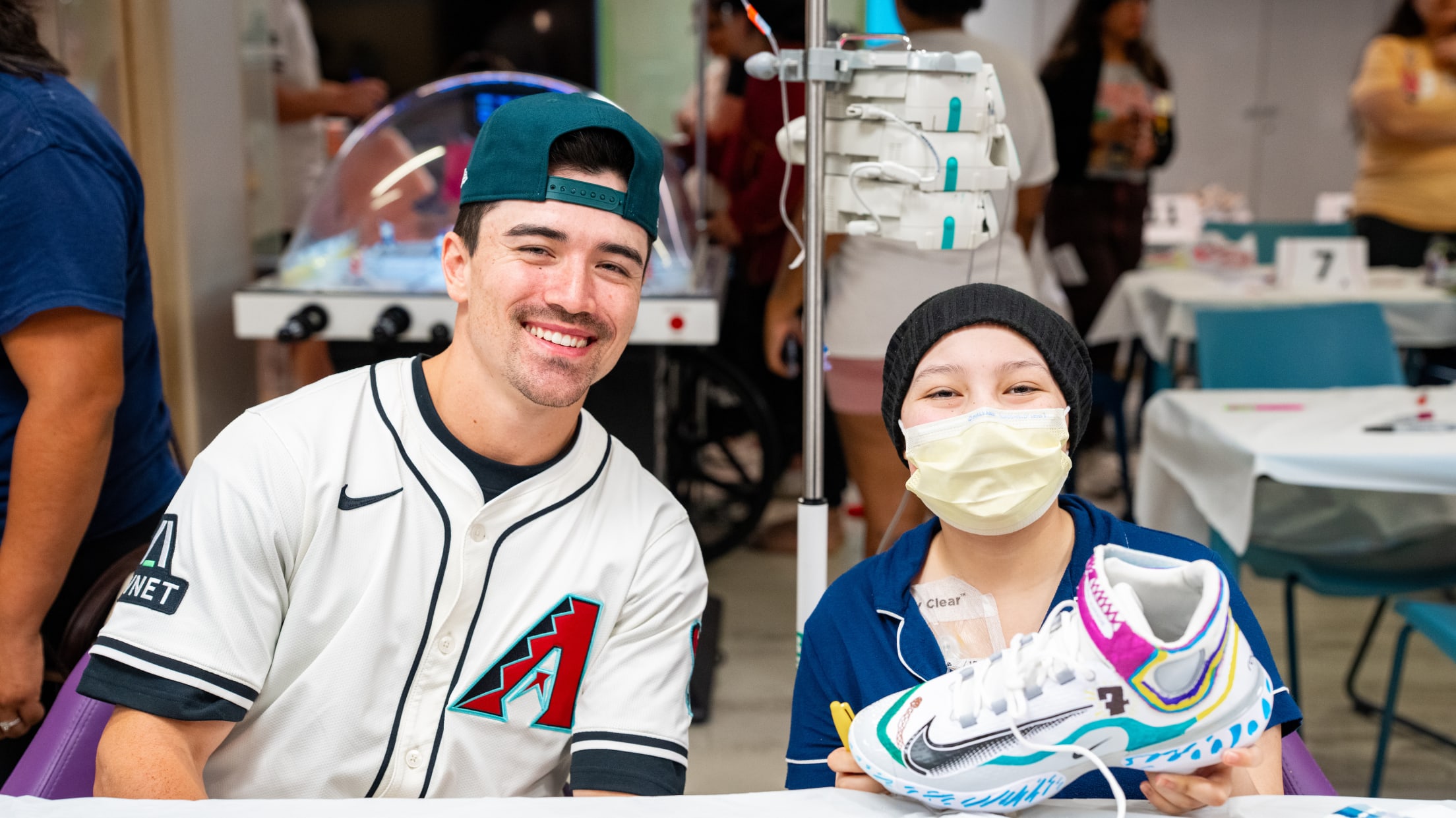 Corbin Carroll takes a picture with a fan participating in Cleats for a Cause at Phoenix Children's Hospital.