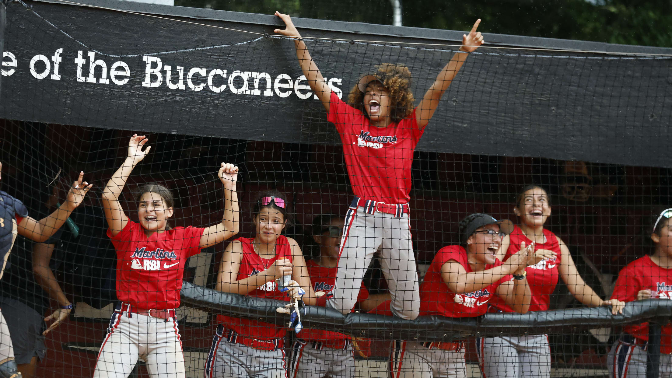 Marlins Nike RBI players celebrate in the dugout.