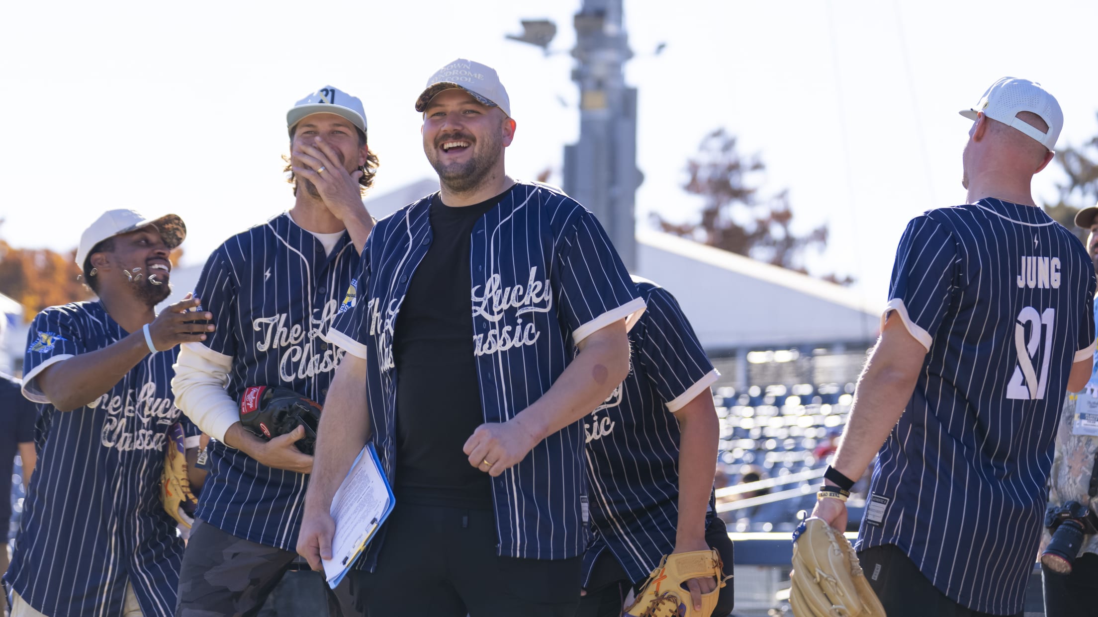 Jake Burger jokes around with others at the Celebrity Softball Game.
