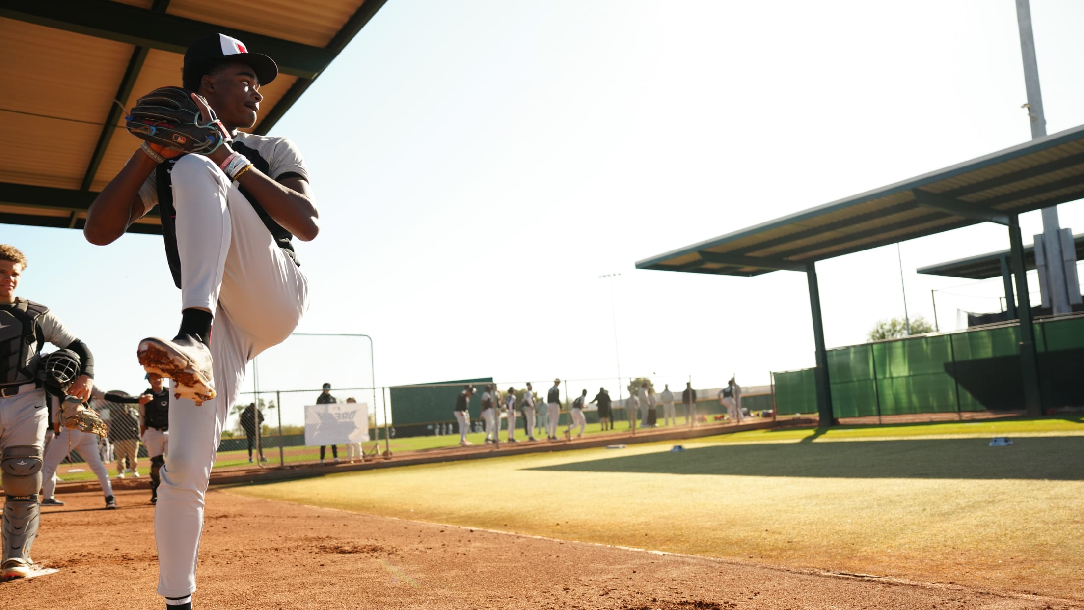 Young male player pitching in a baseball game