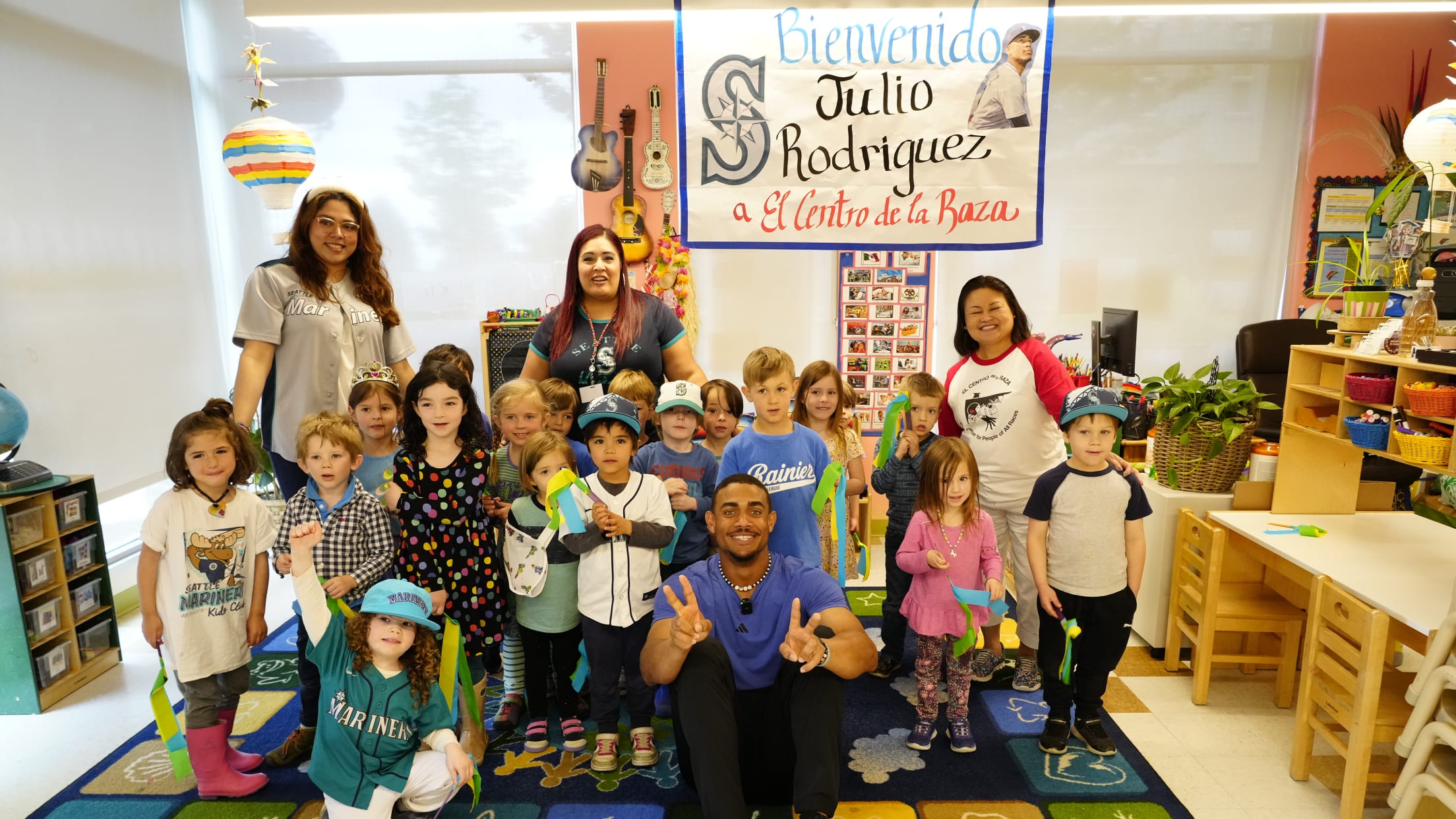 Julio Rodriguez takes a picture with students from El Centro de la Raza preschool.