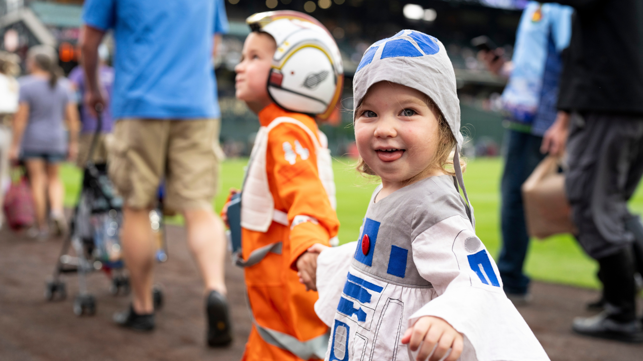 Star Wars fans walking in parade on Coors Field Warning Track