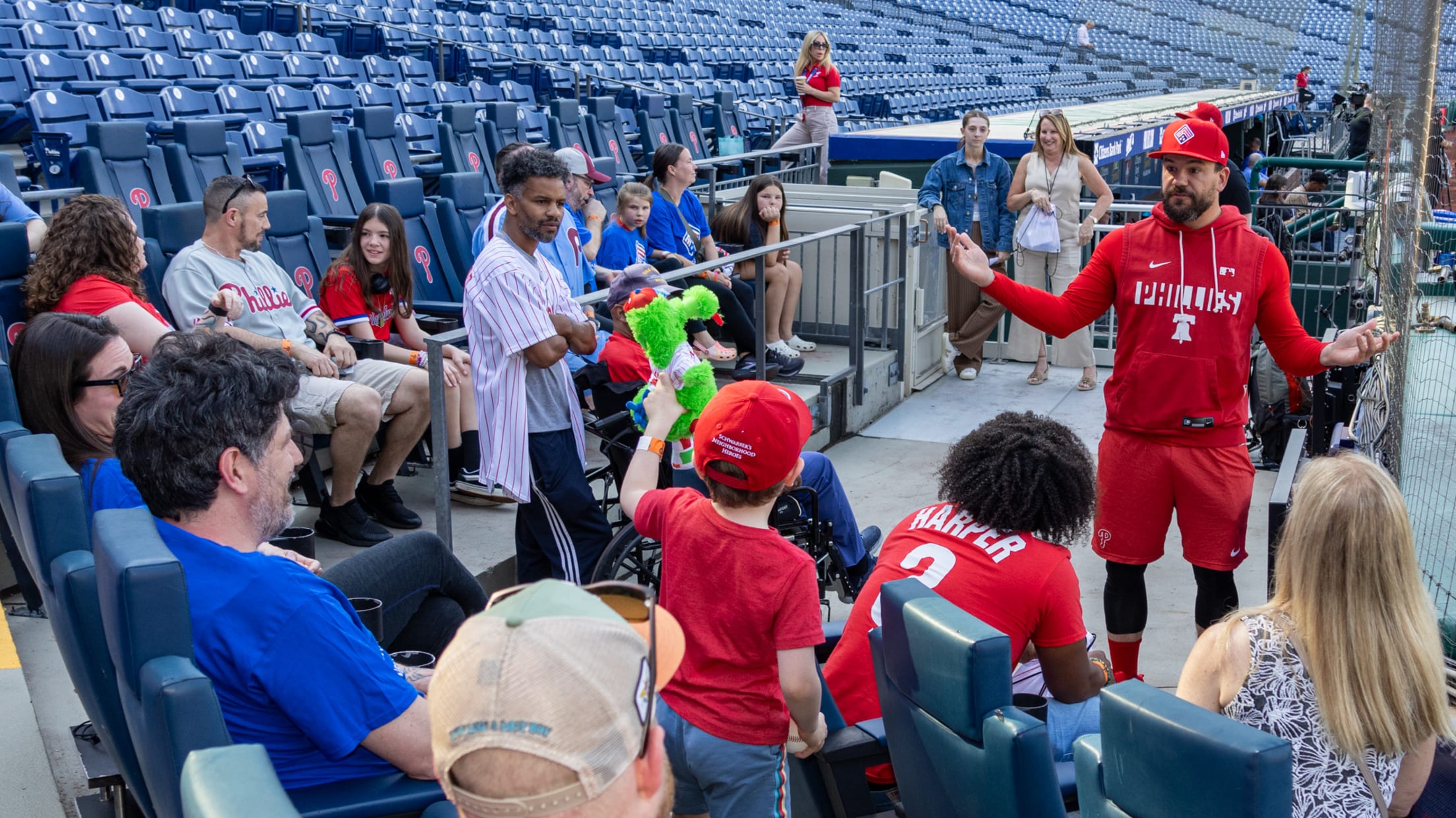 Kyle Schwarber talks to Philadelphia Phillies fans as they participate in Neighborhood Heroes.