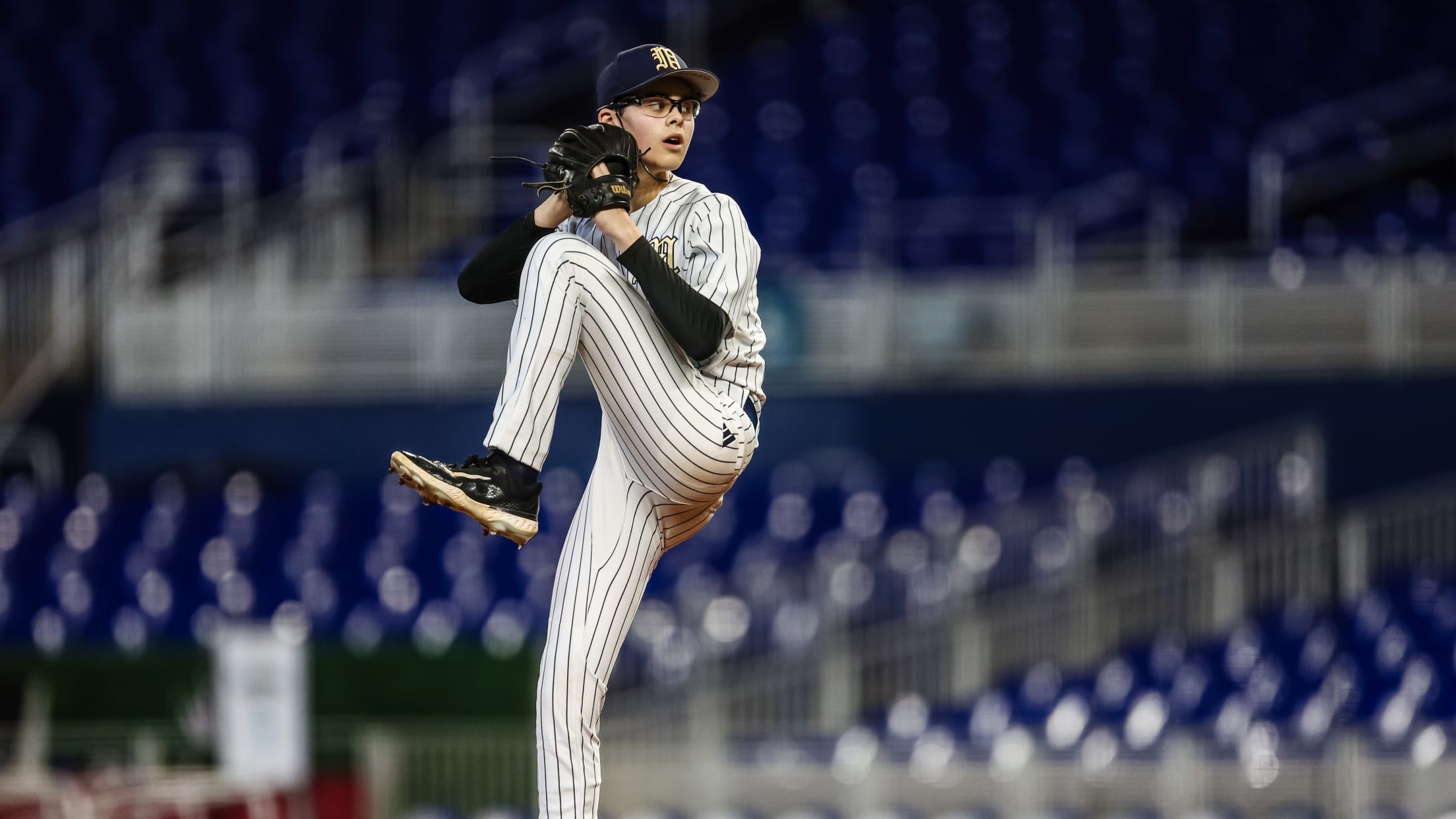 A young pitcher winds up to throw at the Jackie Robinson Classic.