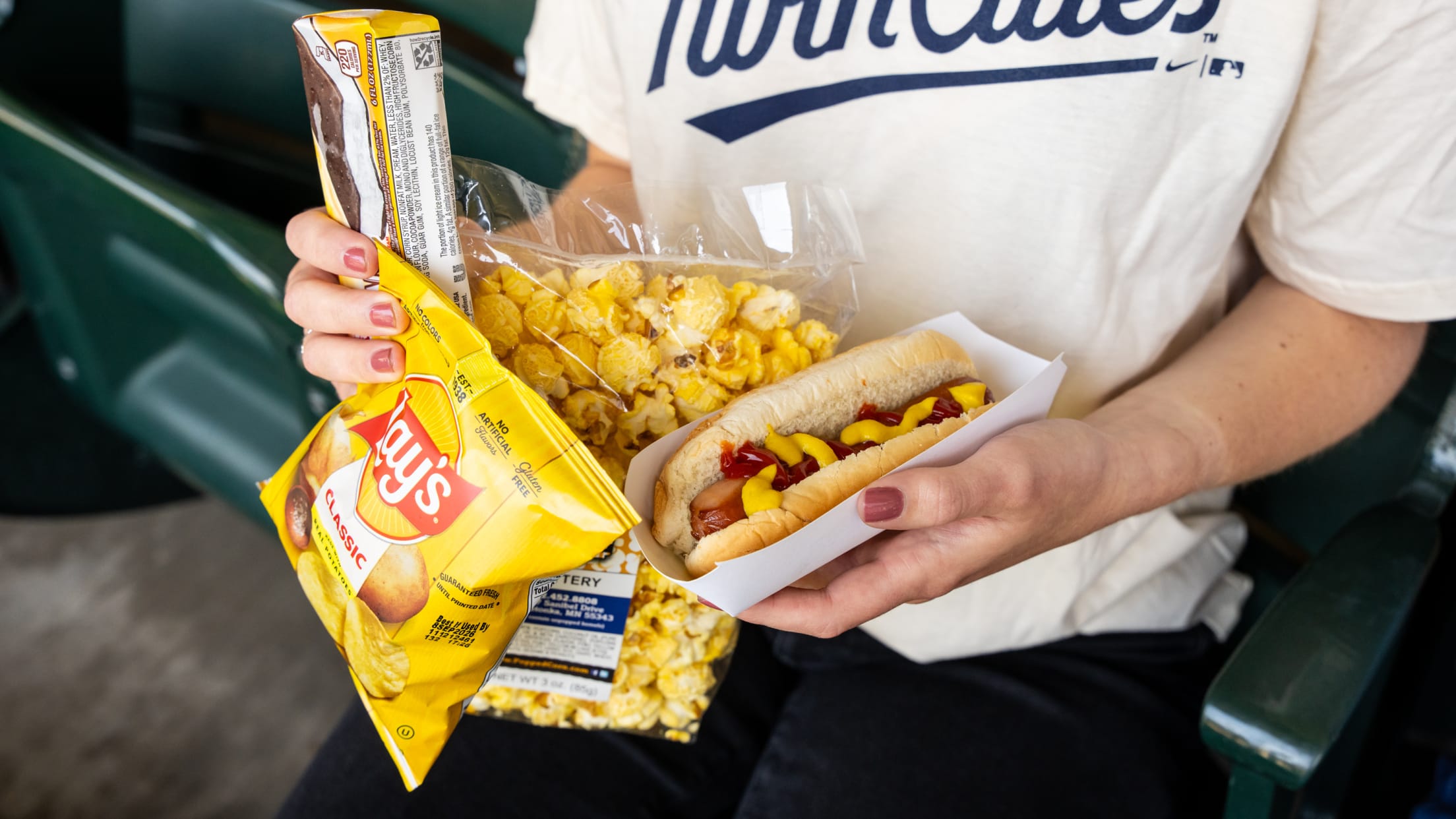 Twins fan holding a hot dog and other food
