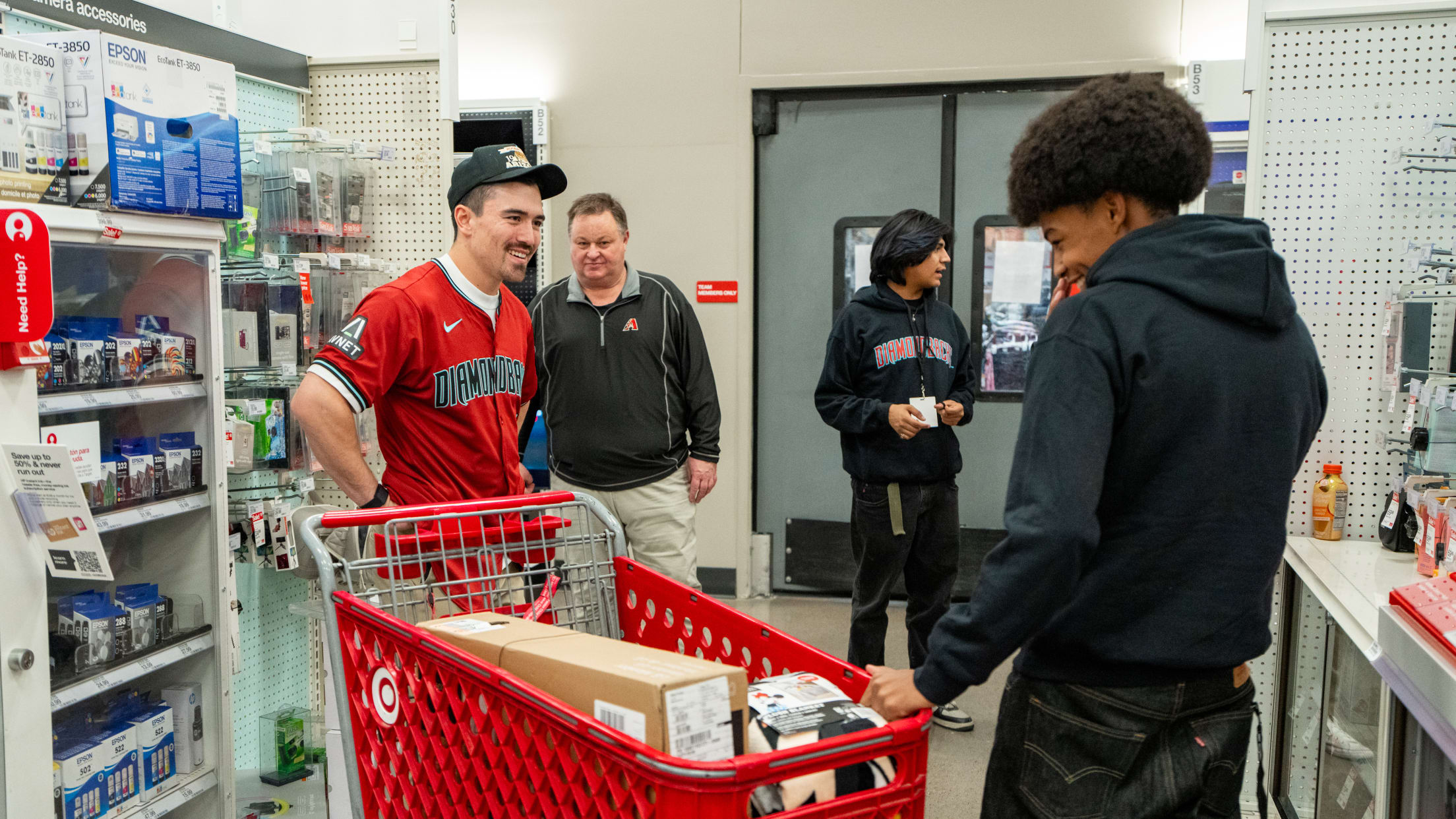 Corbin Carroll assists a teen with shopping at Target as the Diamondbacks partner with A New Leaf to gift 40 teenagers a $250 shopping spree.