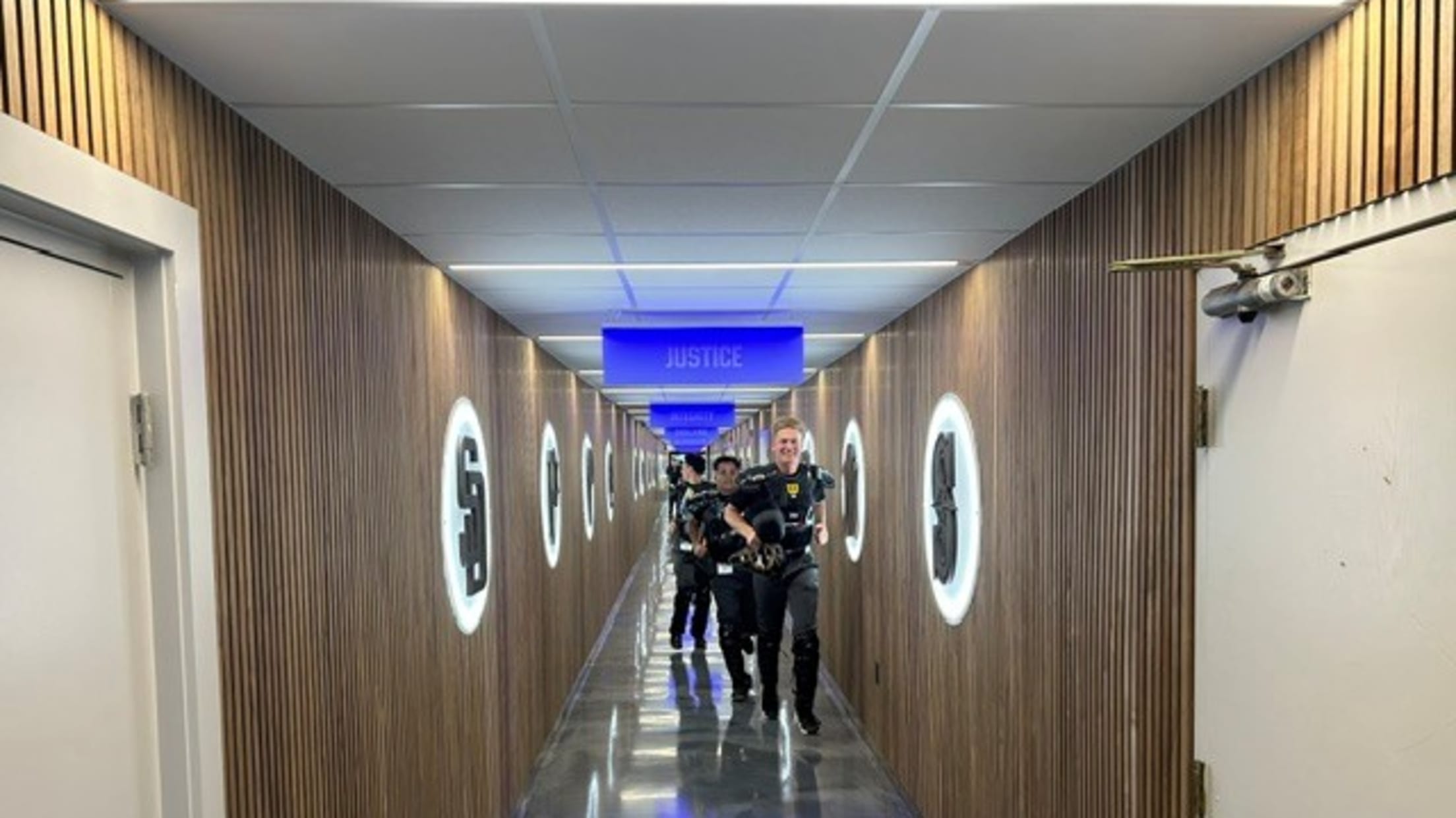 Umpires run down the hall at the Robinson Training Complex.