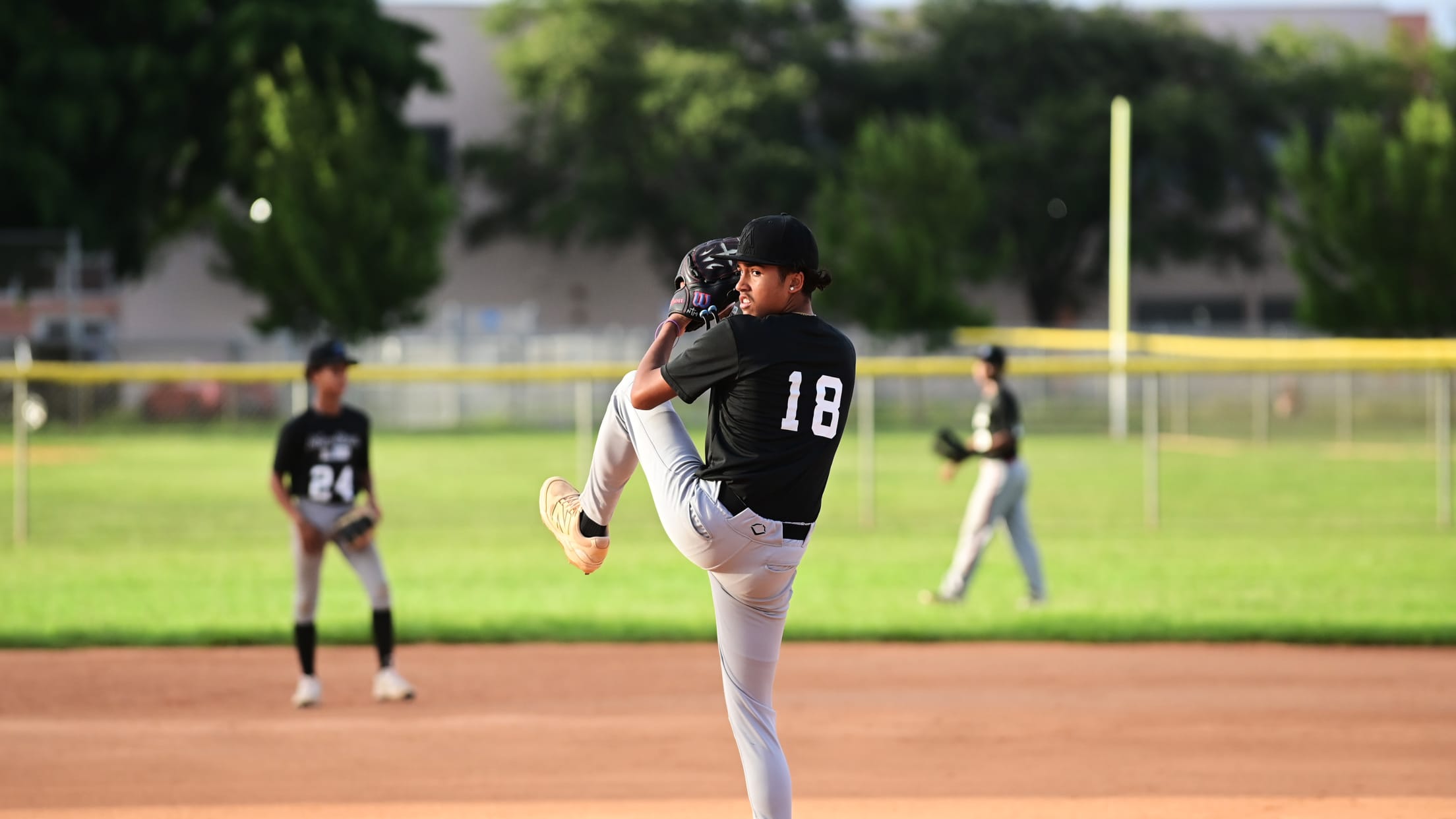 The pitcher winds up as he prepares to deliver a pitch.