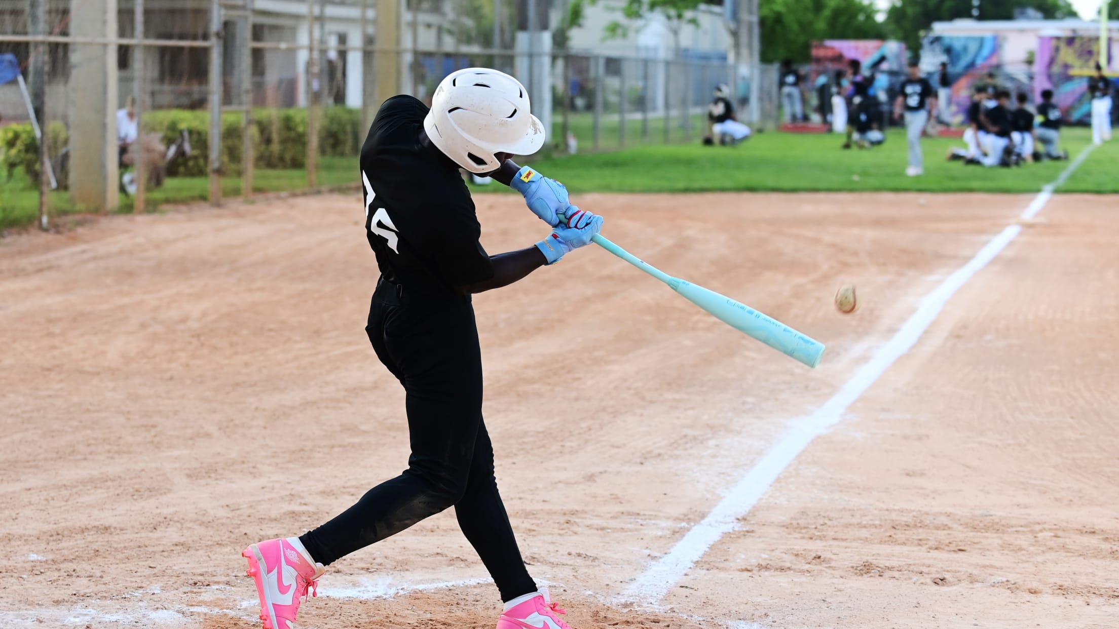 A player swings at the pitch from the batter's box at the Marlins Nike RBI All-Stars Tryouts