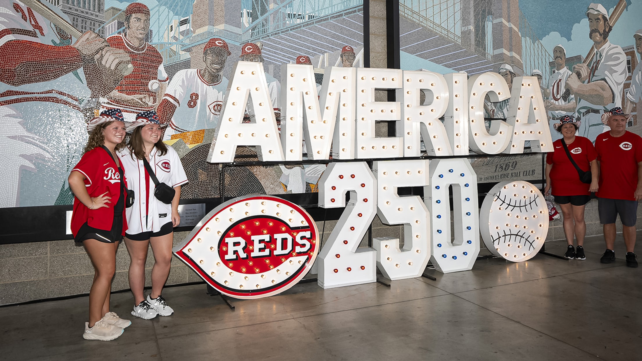 Fans posing next to America250 sign inside Great American Ball Park.