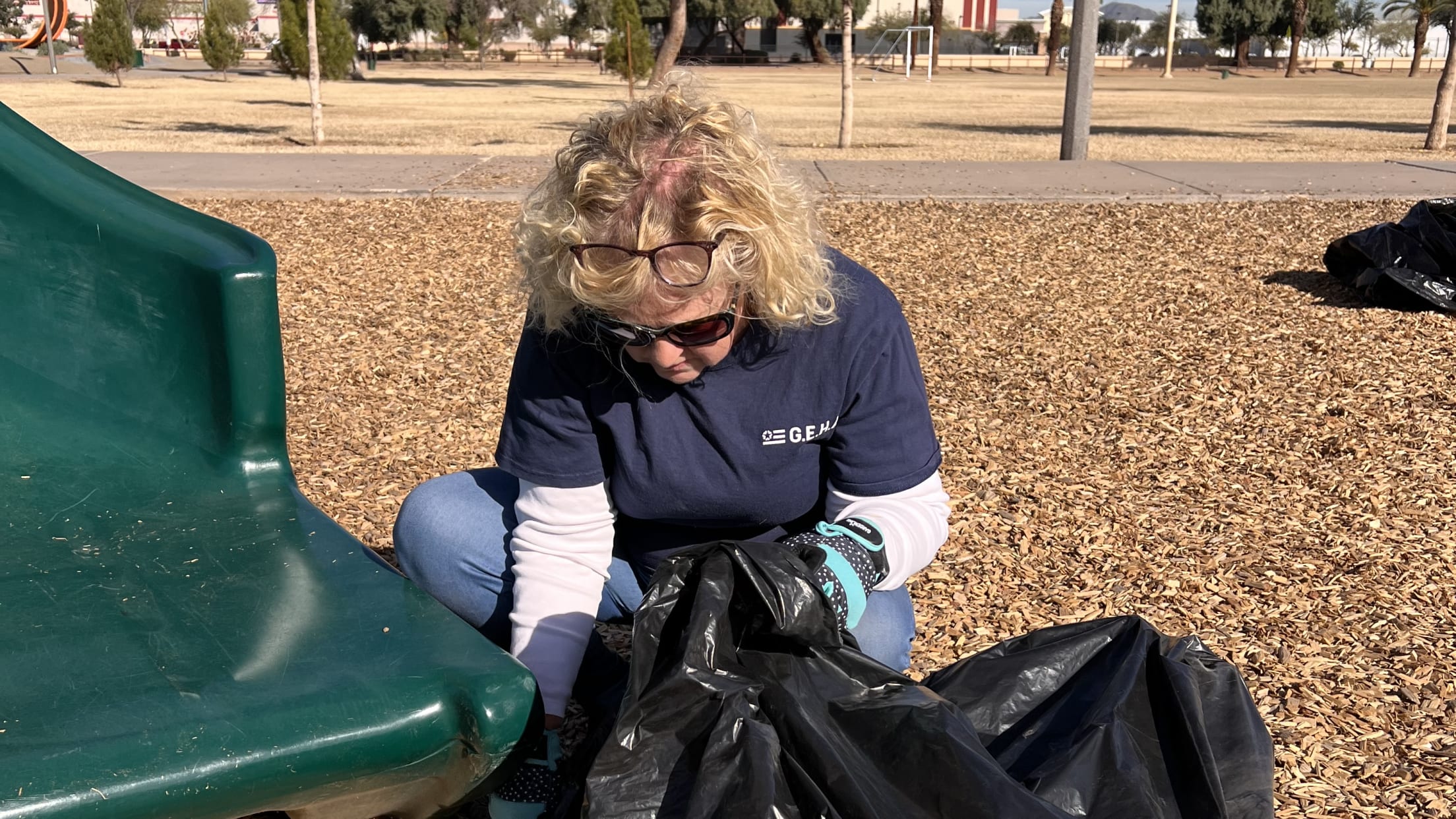 Deborah Hammer picks up trash at a volunteer event.