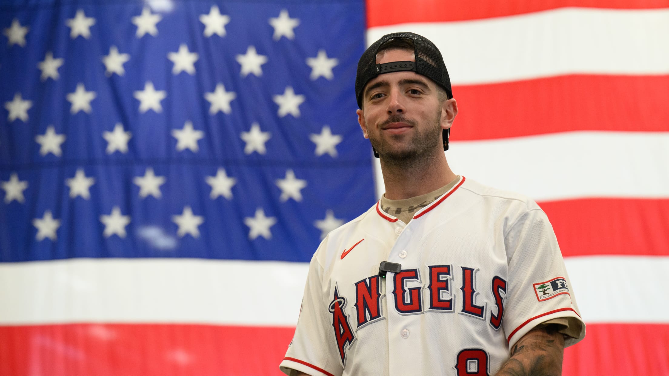 Zach Neto stands in front of a United States flag.
