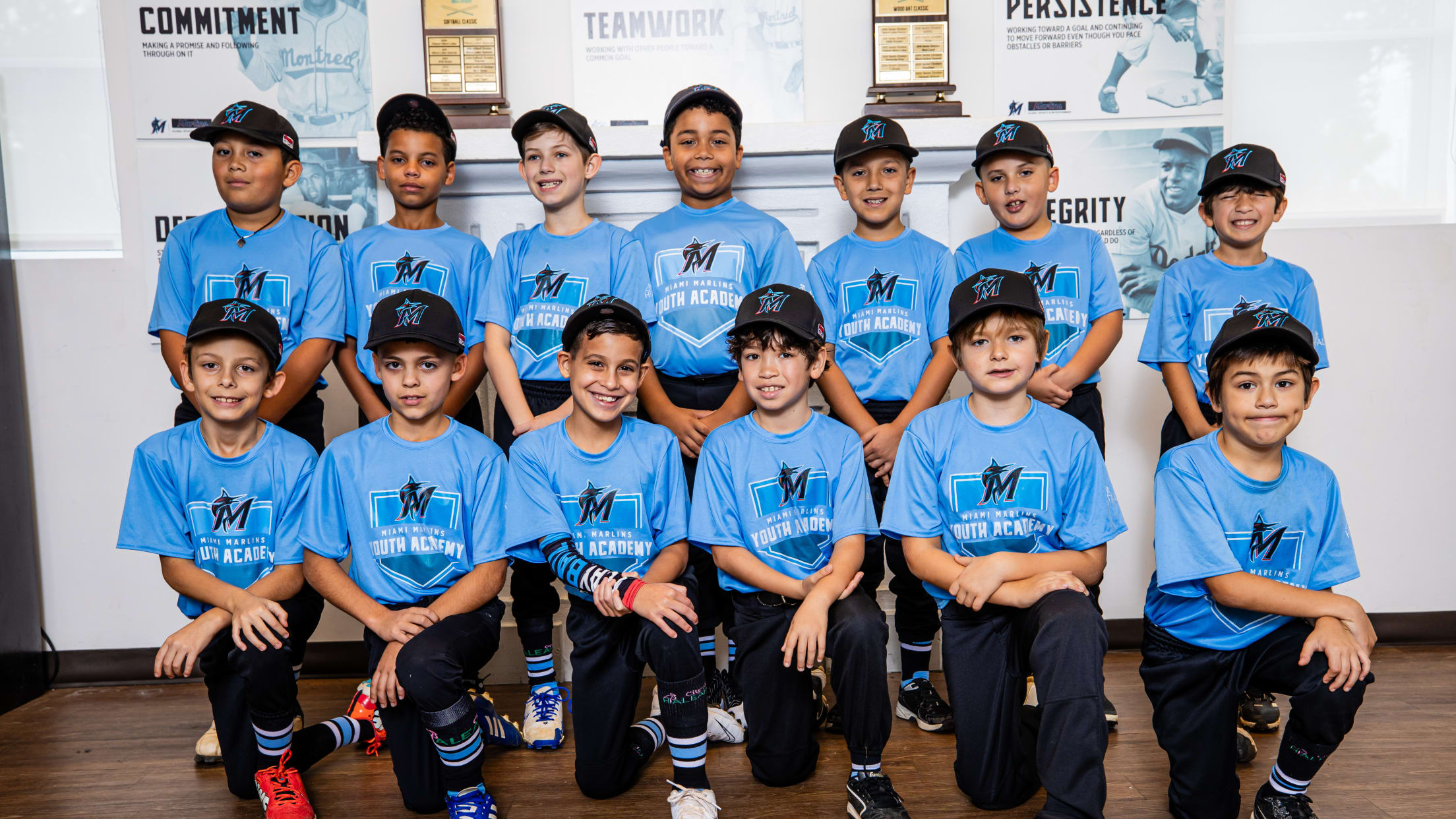 Players from Marlins Youth Academy take a team photo.