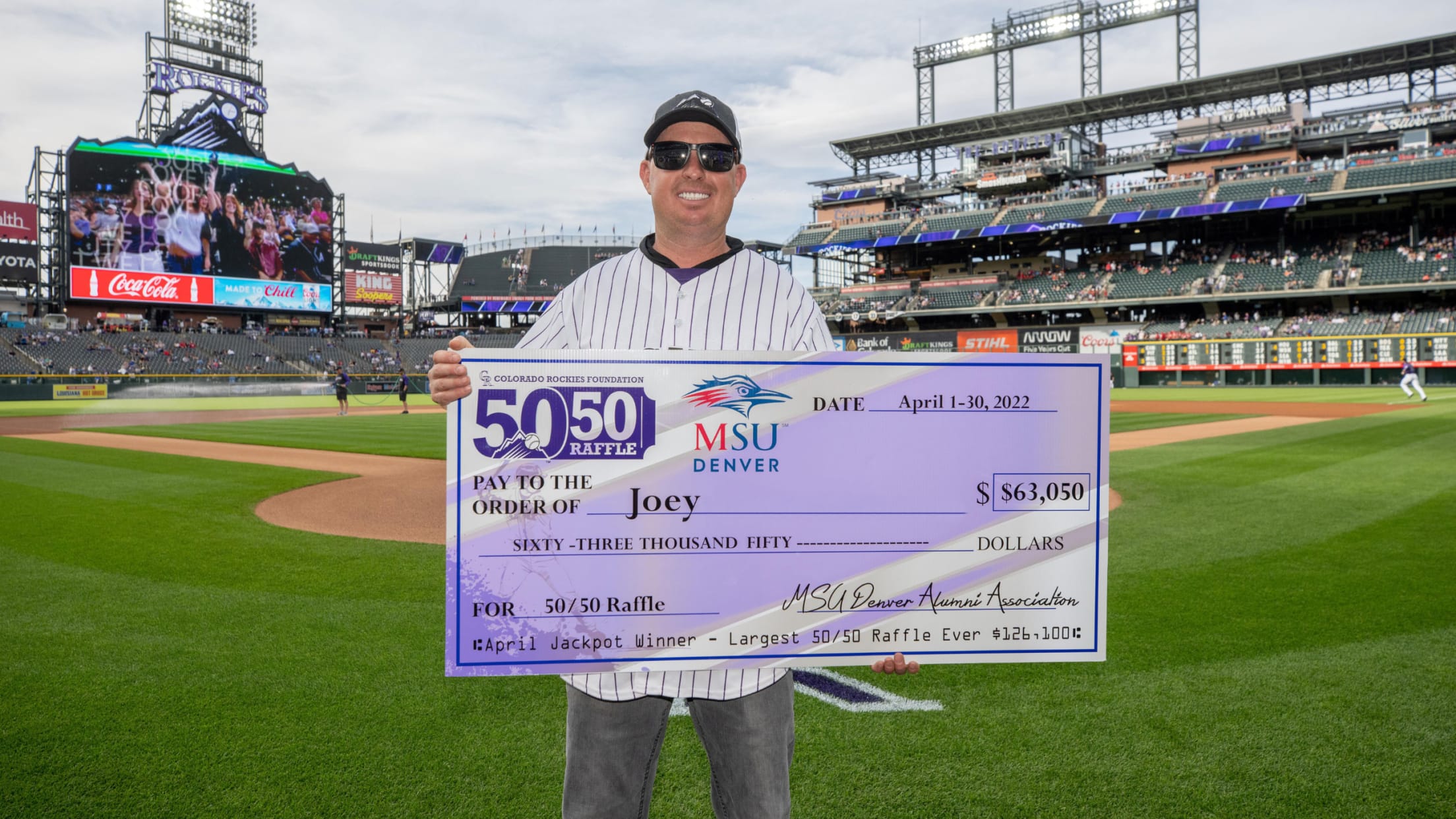 2022 Jackpot winner posing with jumbo check