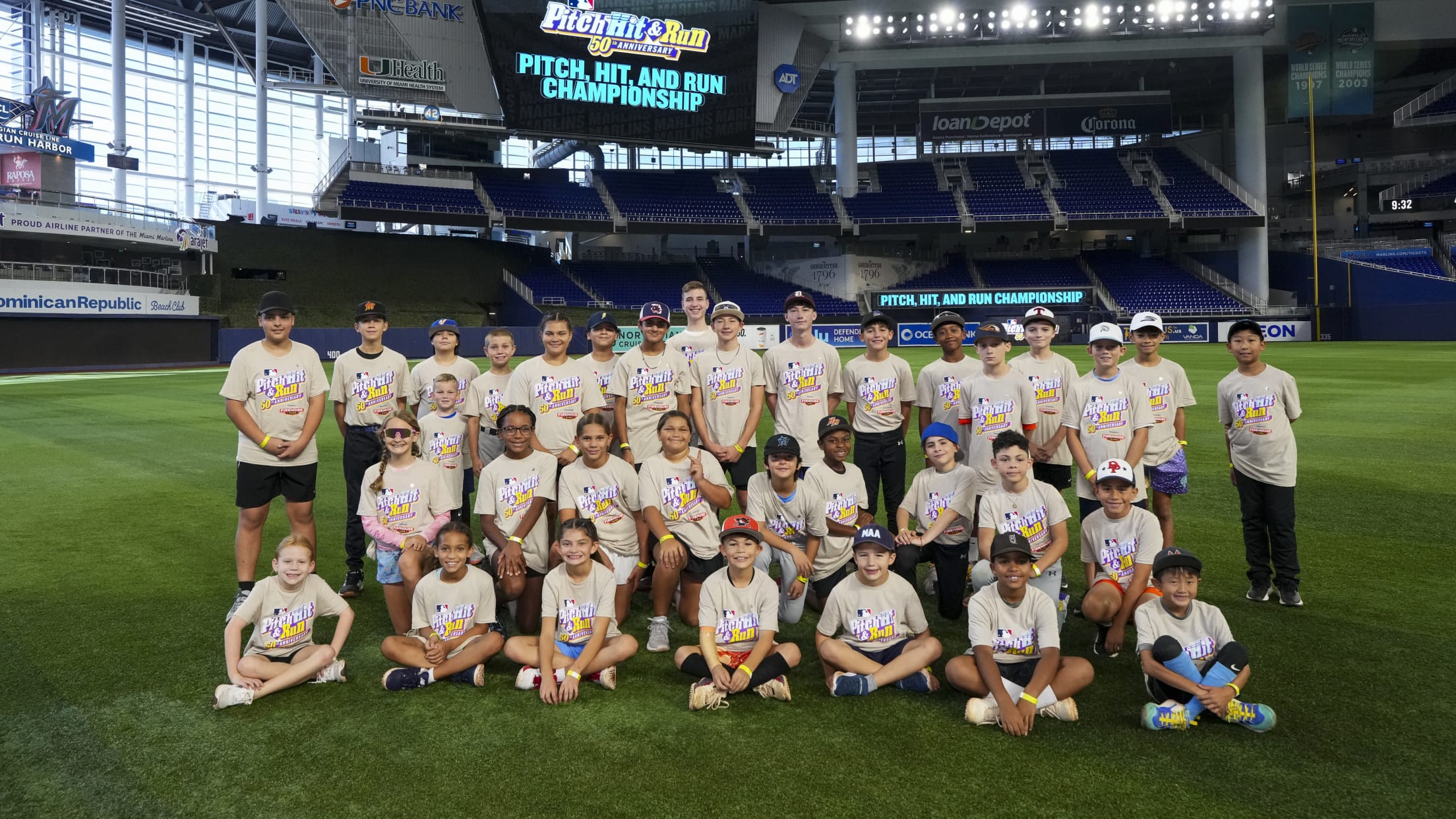 Players pose for a group photo in the outfield at the MLB Pitch, Hit & Run Championship.