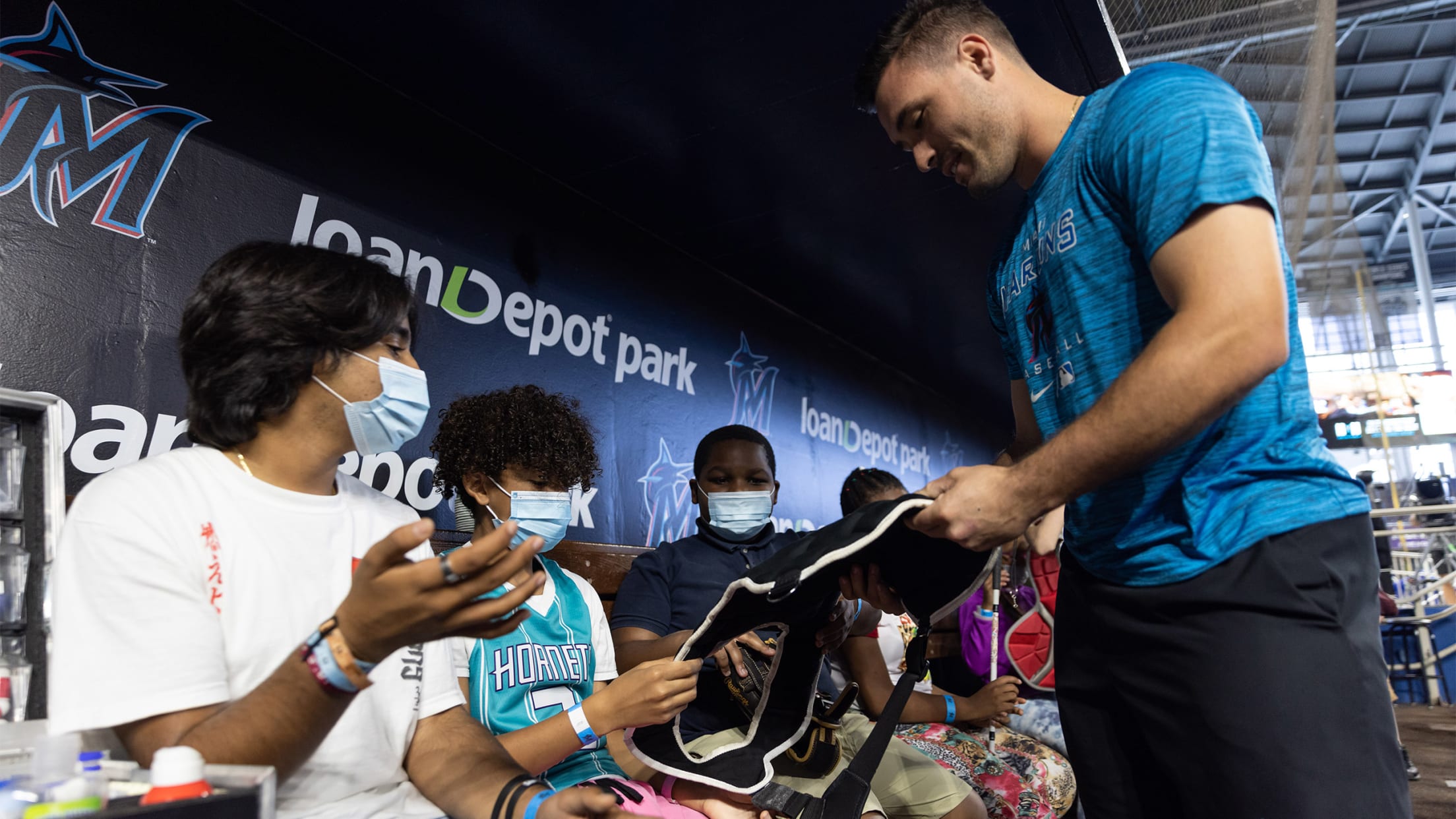 Marlins player interacting with children