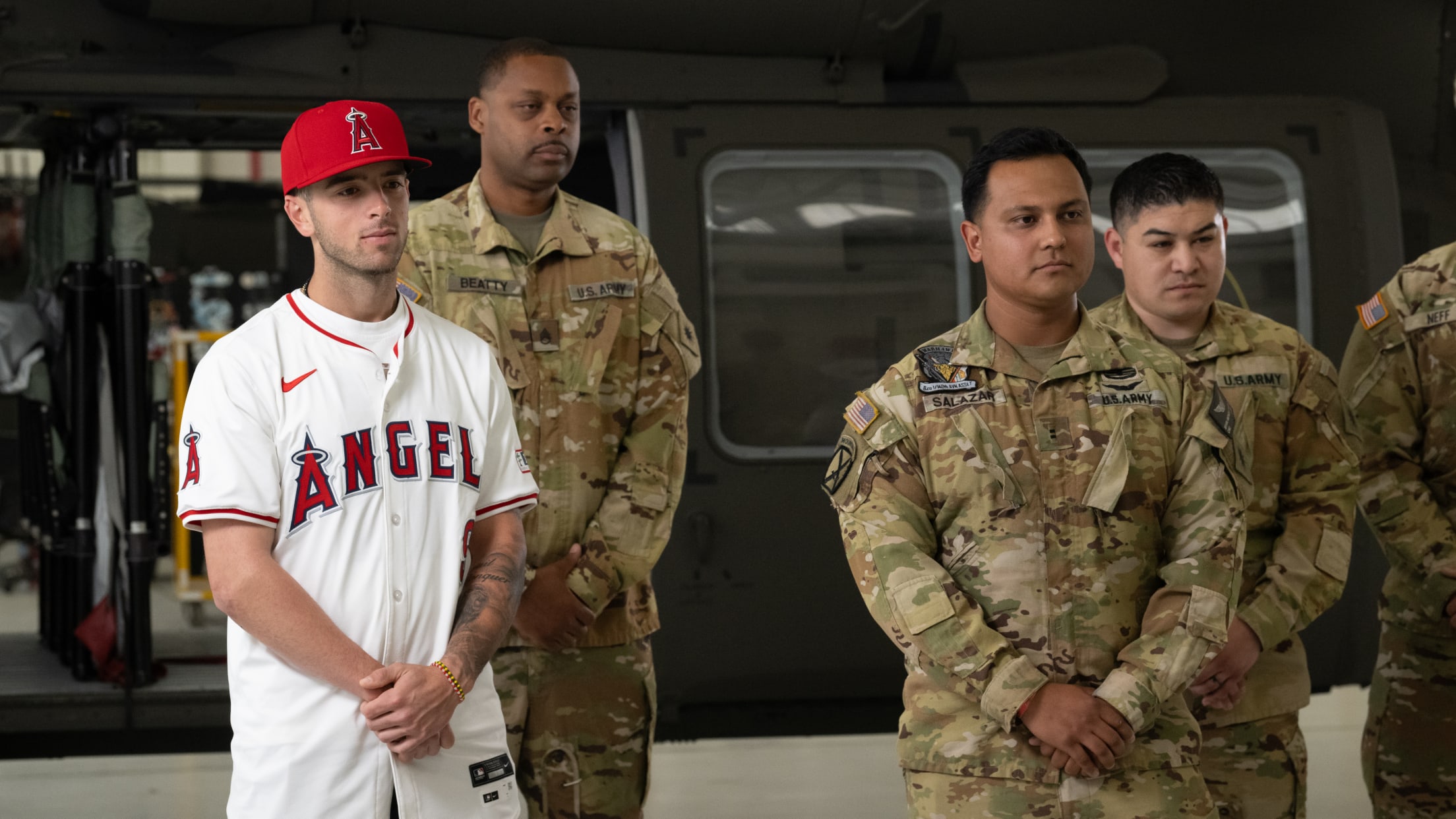 Zach Neto takes a group picture with a United States service members.