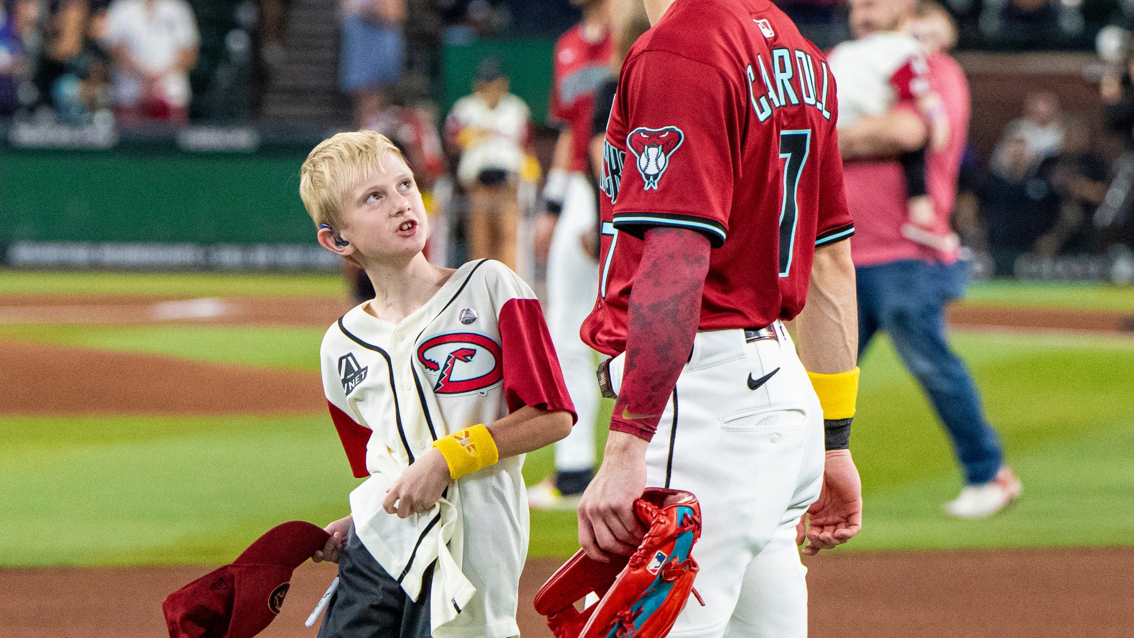Corbin Carroll takes the field with a fan at Chase Field.