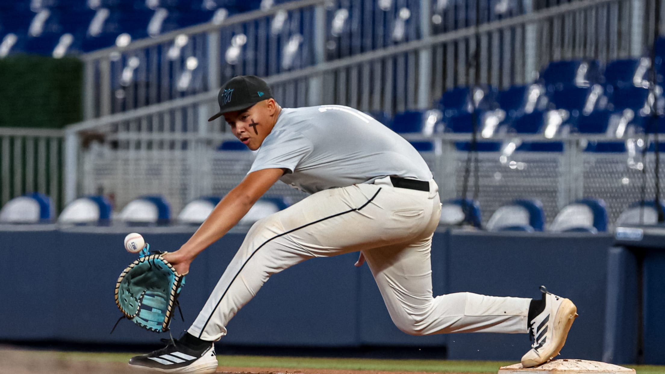 The first baseman bends down to reach a throw during the Marlins Nike RBI Wood Bat Championship.