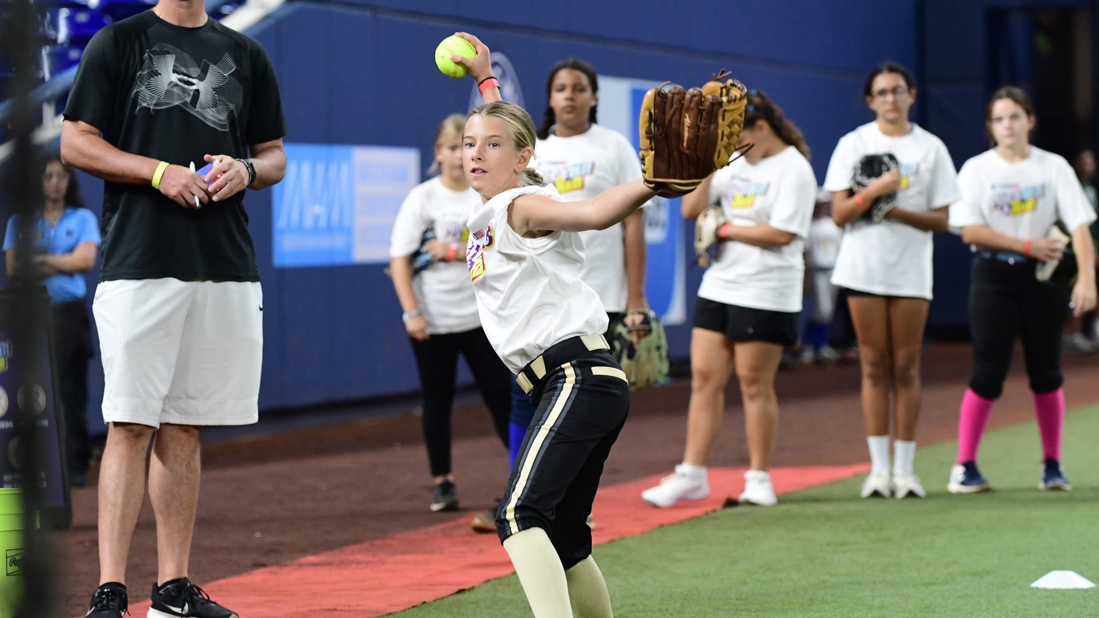 A softball player practices her pitching at Pitch, Hit & Run.