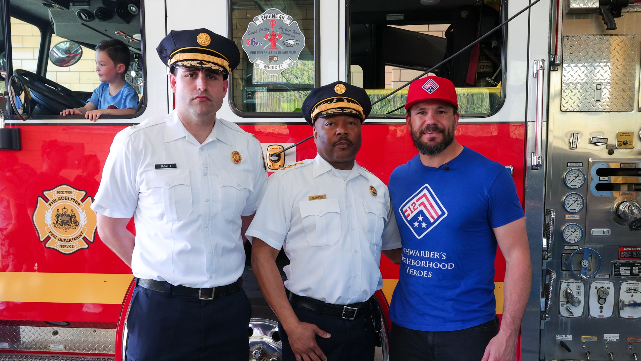 Kyle Schwarber takes a photo with firefighters from Engine 11.