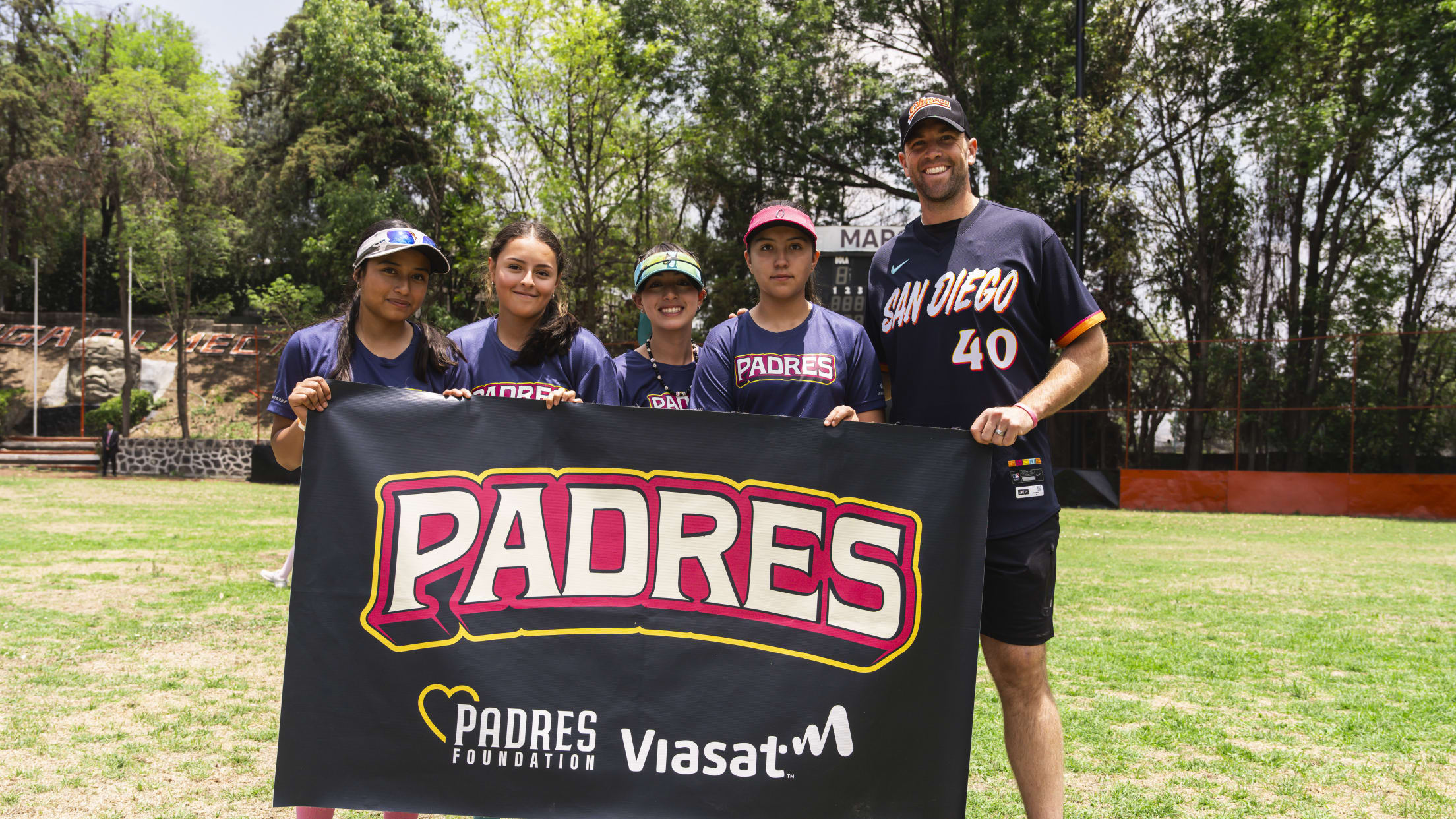 Jason Adam takes a picture with players from a youth clinic in Mexico City.