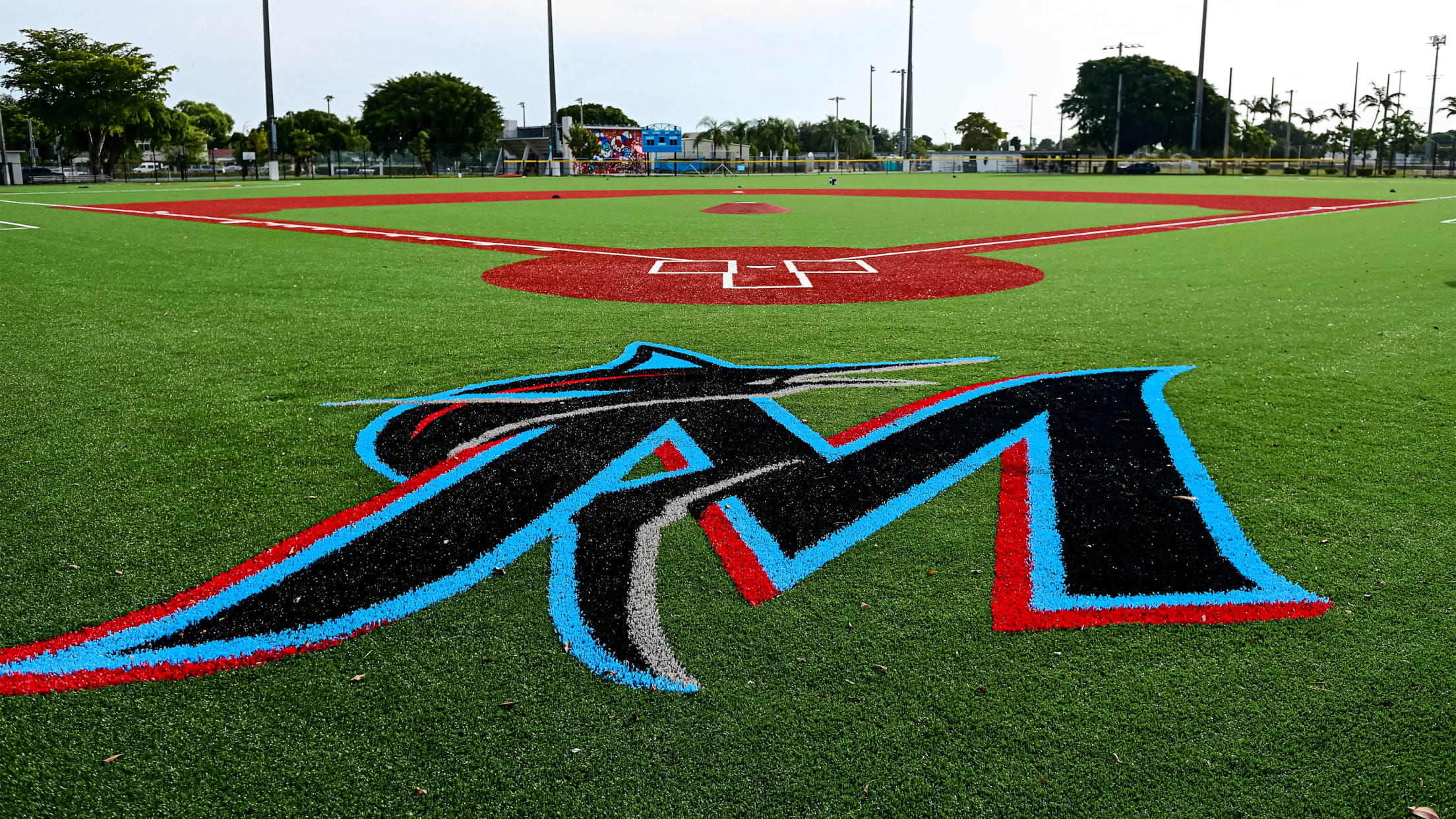 The Marlins logo behind home plate at the Miami Marlins Youth Academy facility.