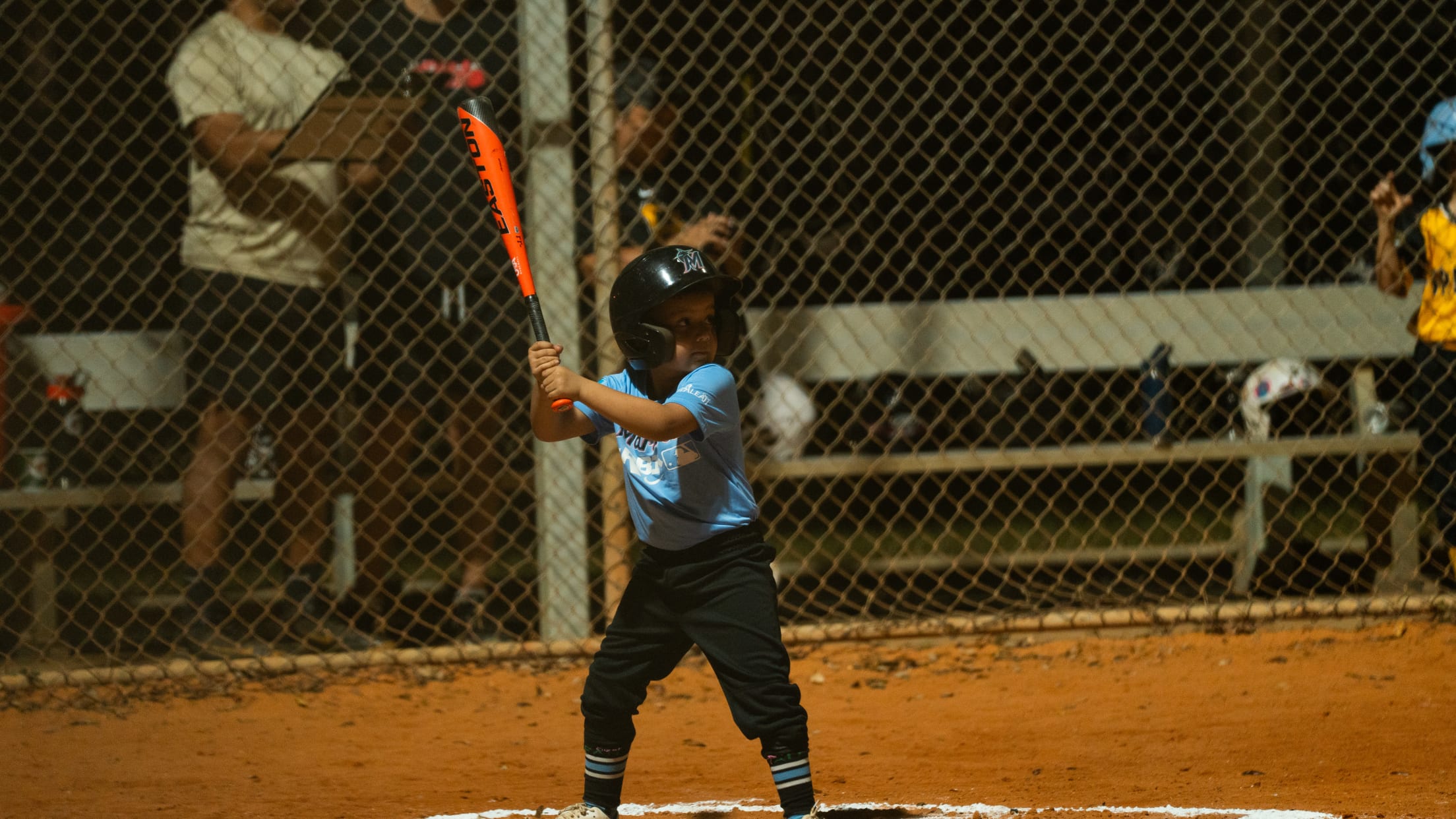 A young player stands up to bat at the Marlins Nike Jr. RBI program.