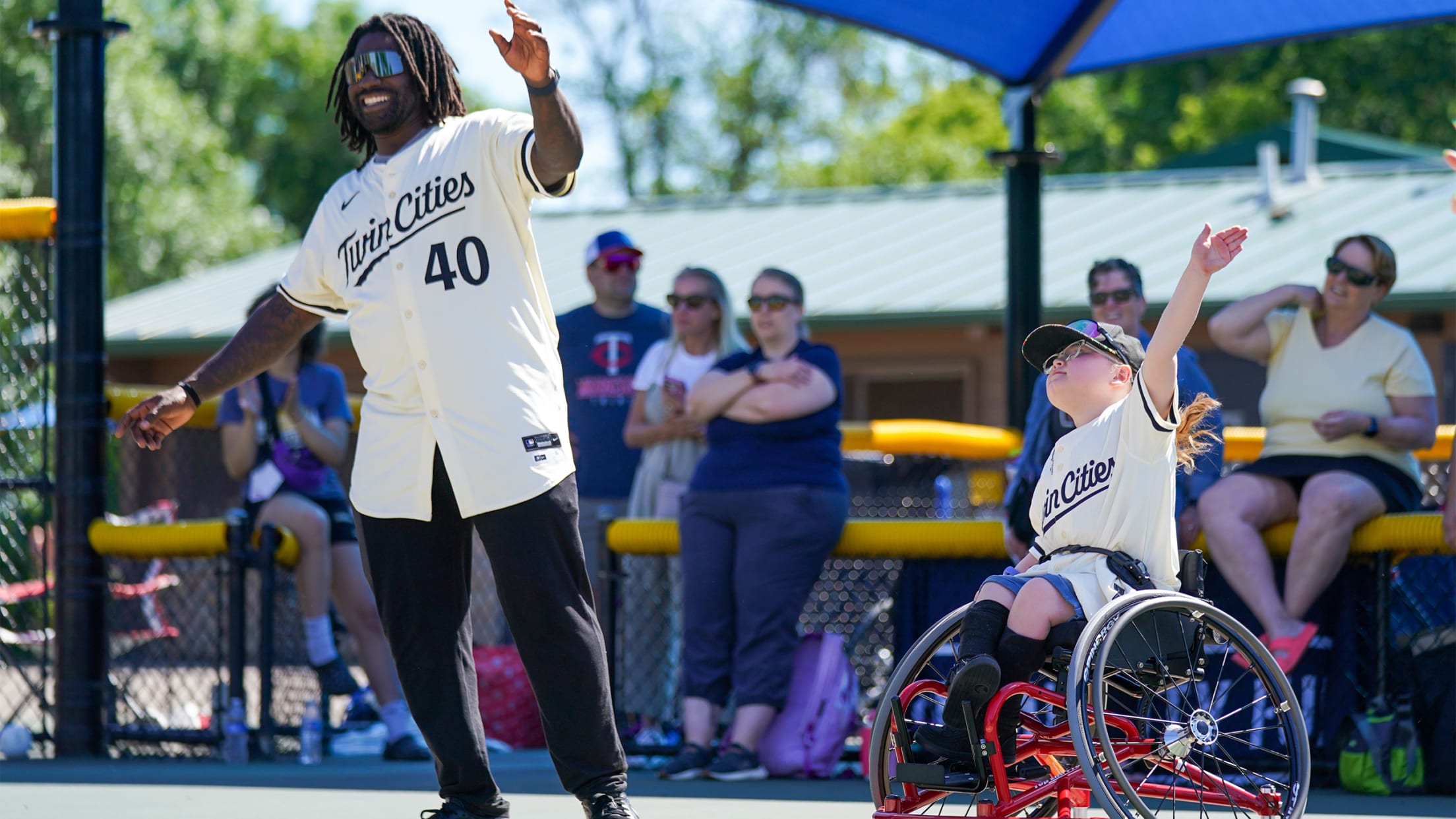 Tommy Watkins with a young athlete at the Twins Community Fund adaptive wheelchair softball clinic