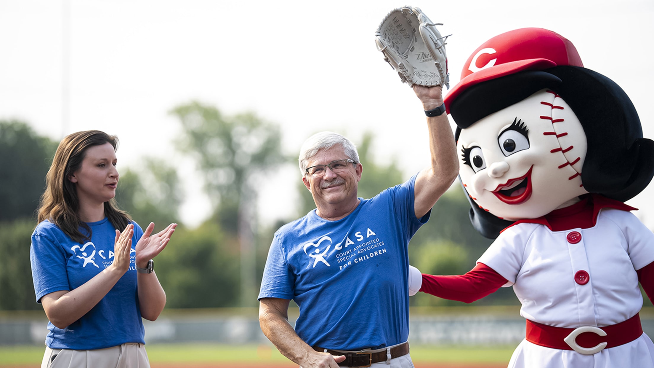 Members of Ohio CASA are introduced alongside Rosie Red during a pregame ceremony.