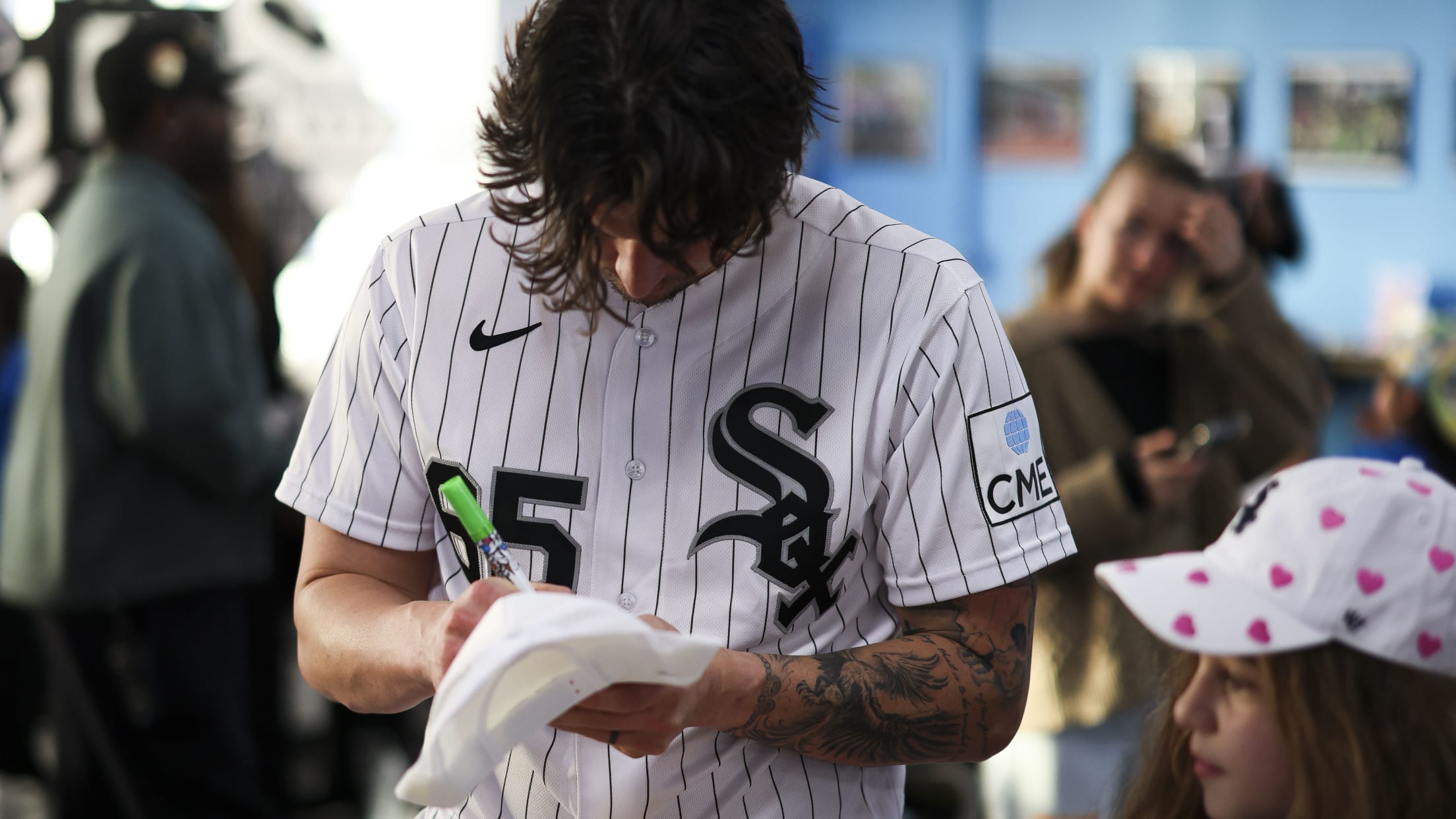 Davis Martin signs a cap for a Chicago White Sox fan.