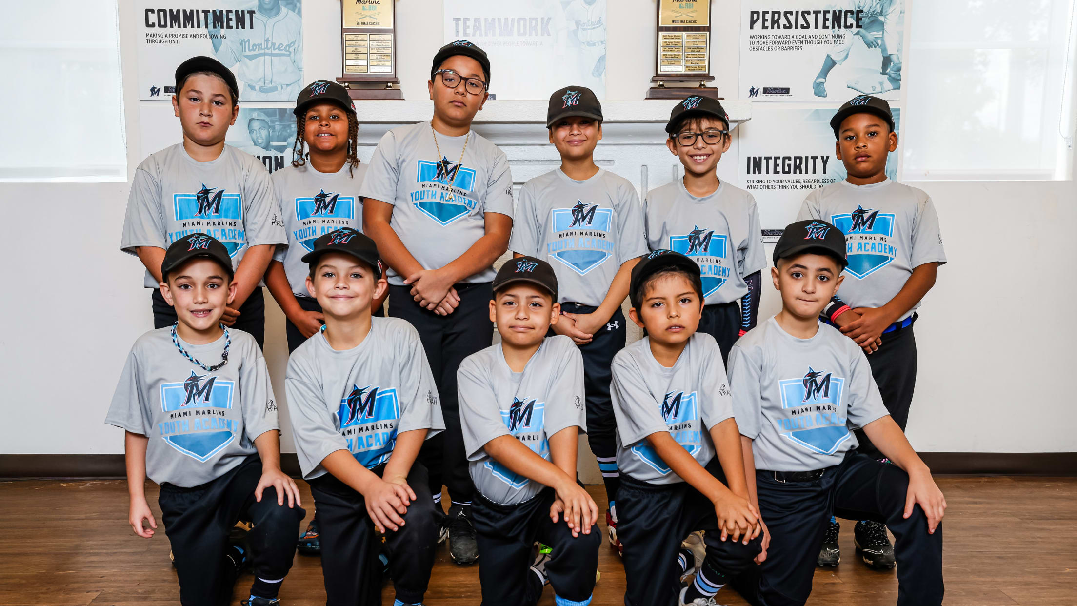 Players from Marlins Youth Academy take a team photo.