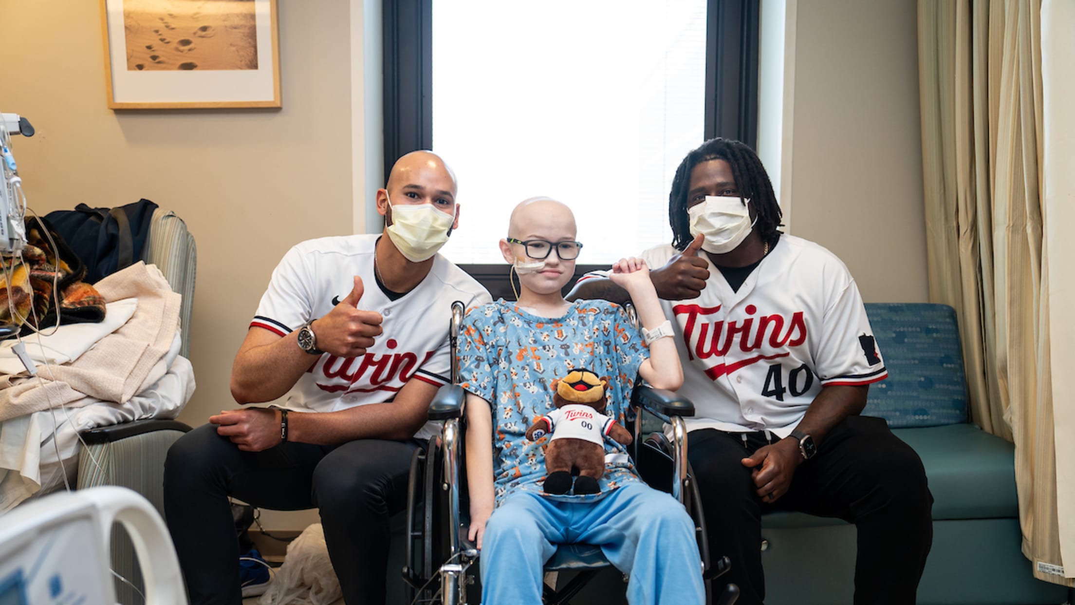 Pablo López and Tommy Watkins take a picture with a fan at the Minnesota Children's Hospital.