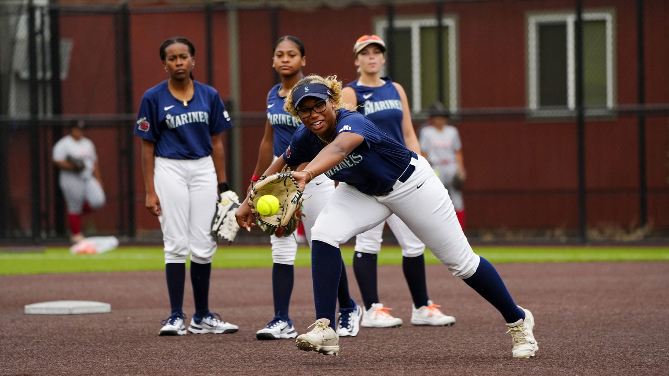 Image of young women playing softball.