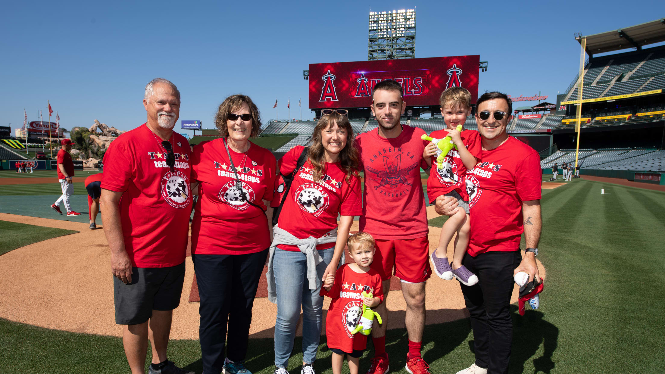 Zach Neto takes a picture with Los Angeles Angels fans on the field at Angel Stadium.