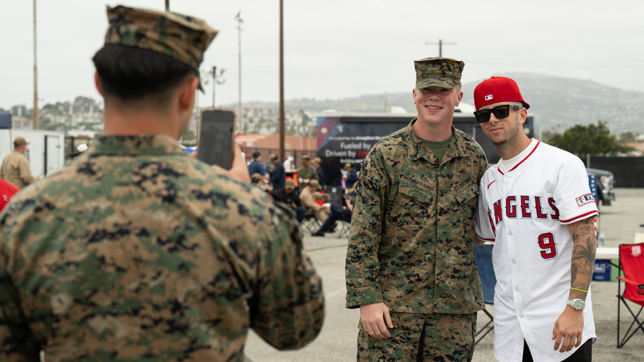 Zach Neto takes a photo with a United States service member.
